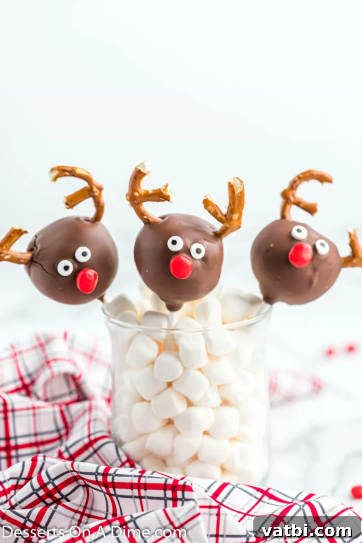 Festive Reindeer Cake Pops 9 Cake pops in stand. Finished reindeer cake pops displayed upright in a cake pop stand, drying.