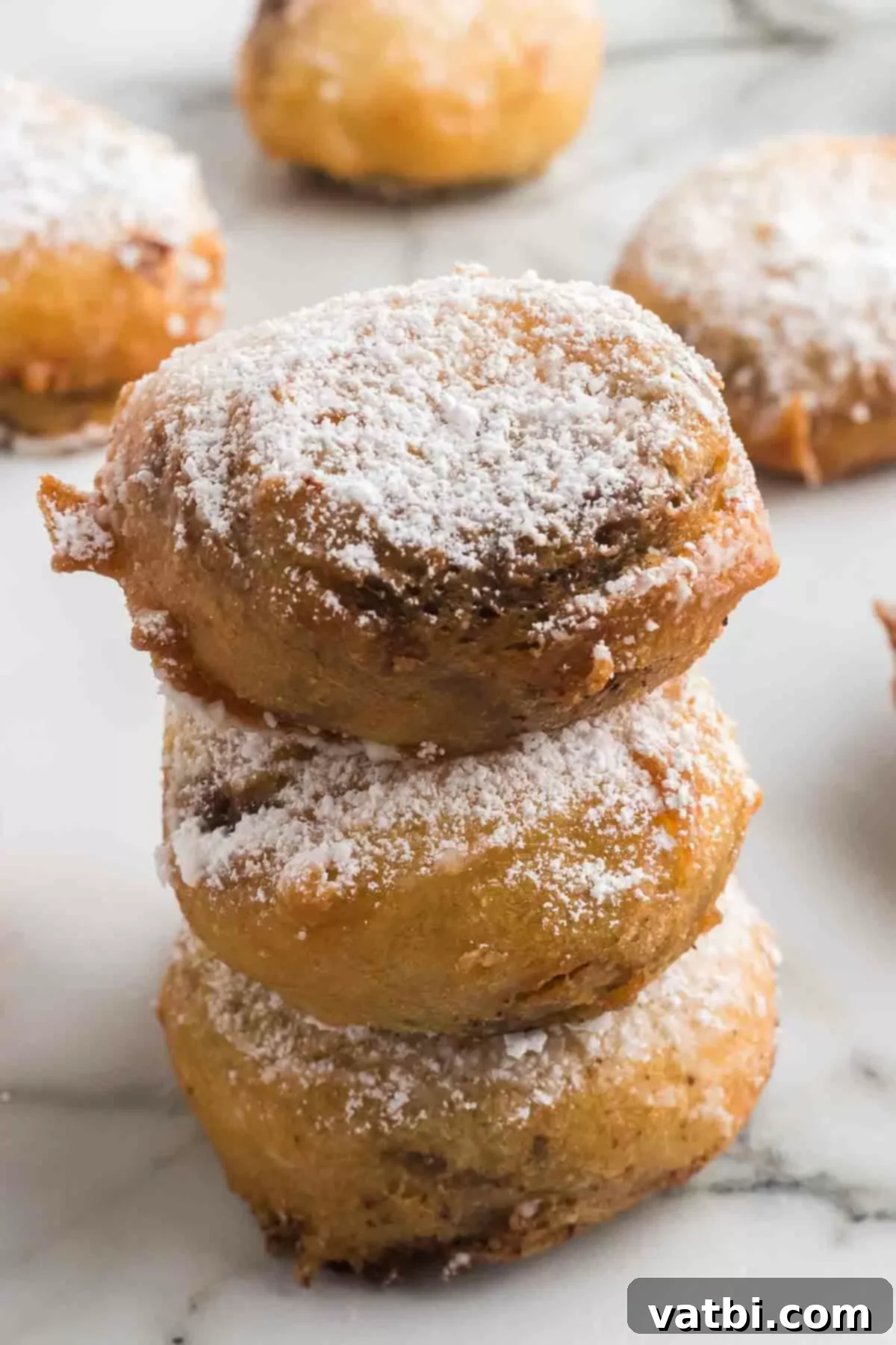 Deep Fried Peanut Butter Bliss 2 Deep fried reese's peanut butter cups stacked, showcasing their golden-brown exterior.