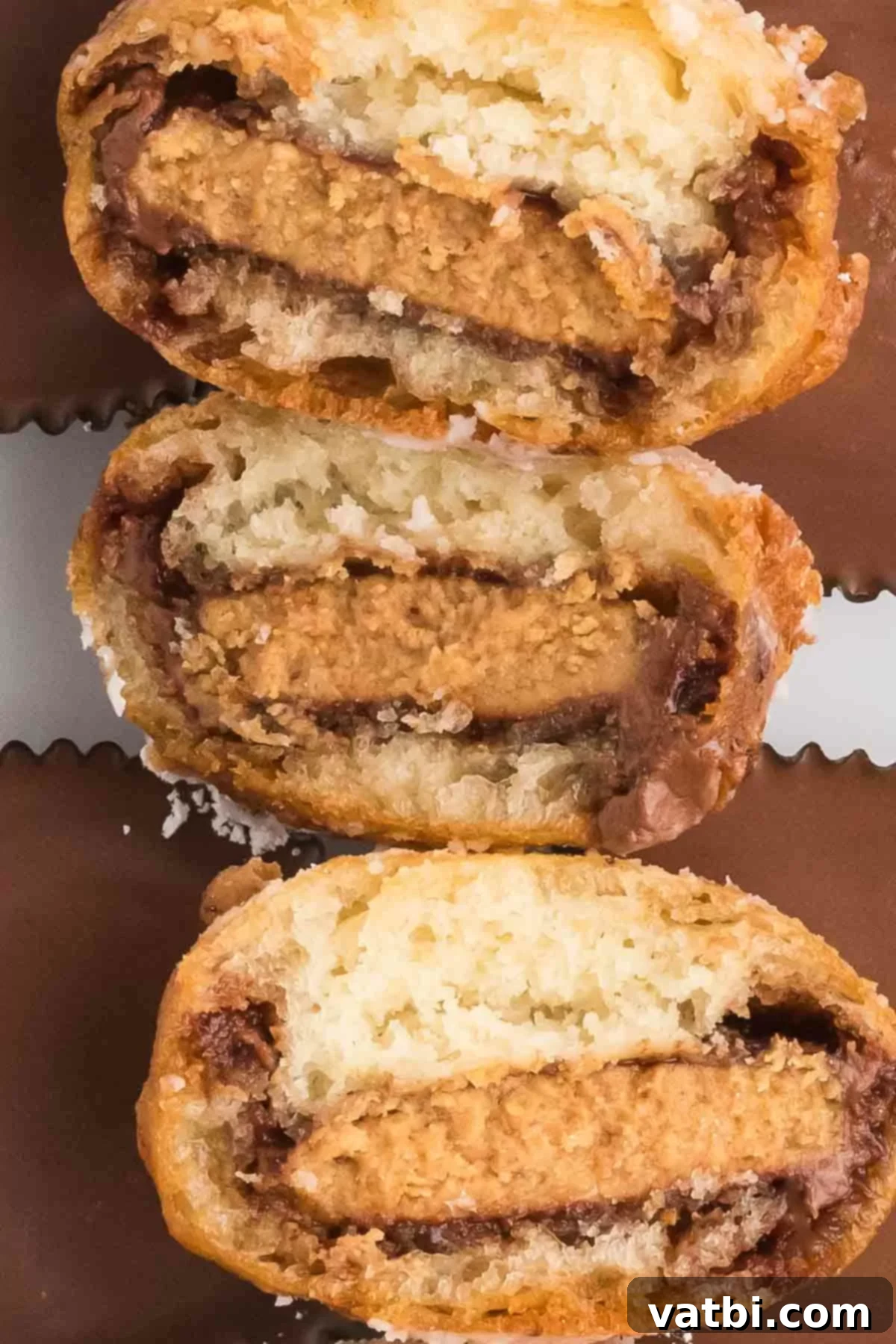 Deep Fried Peanut Butter Bliss 13 Deep fried reese's peanut butter cups stacked together and one cut in half to show the melted interior.