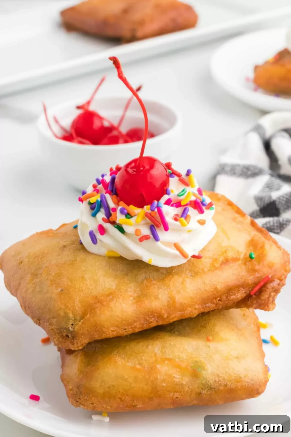 Golden Crisp Pop Tart Heaven 2 Deep fried pop tarts with toppings of whipped cream, sprinkles, and a cherry on top.