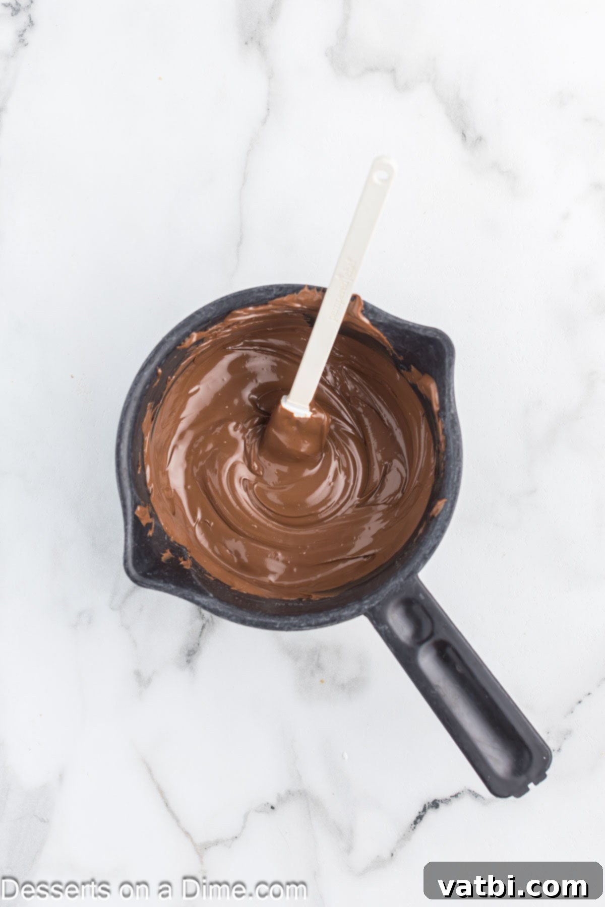 Cozy Cocoa Crunch Mix 4 Melted chocolate in saucepan.