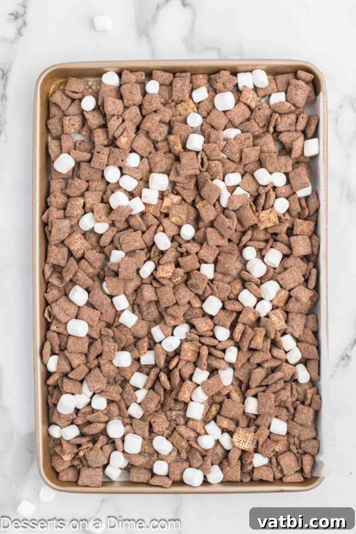Cozy Cocoa Crunch Mix 9 Marshmallows in cereal on a pan.