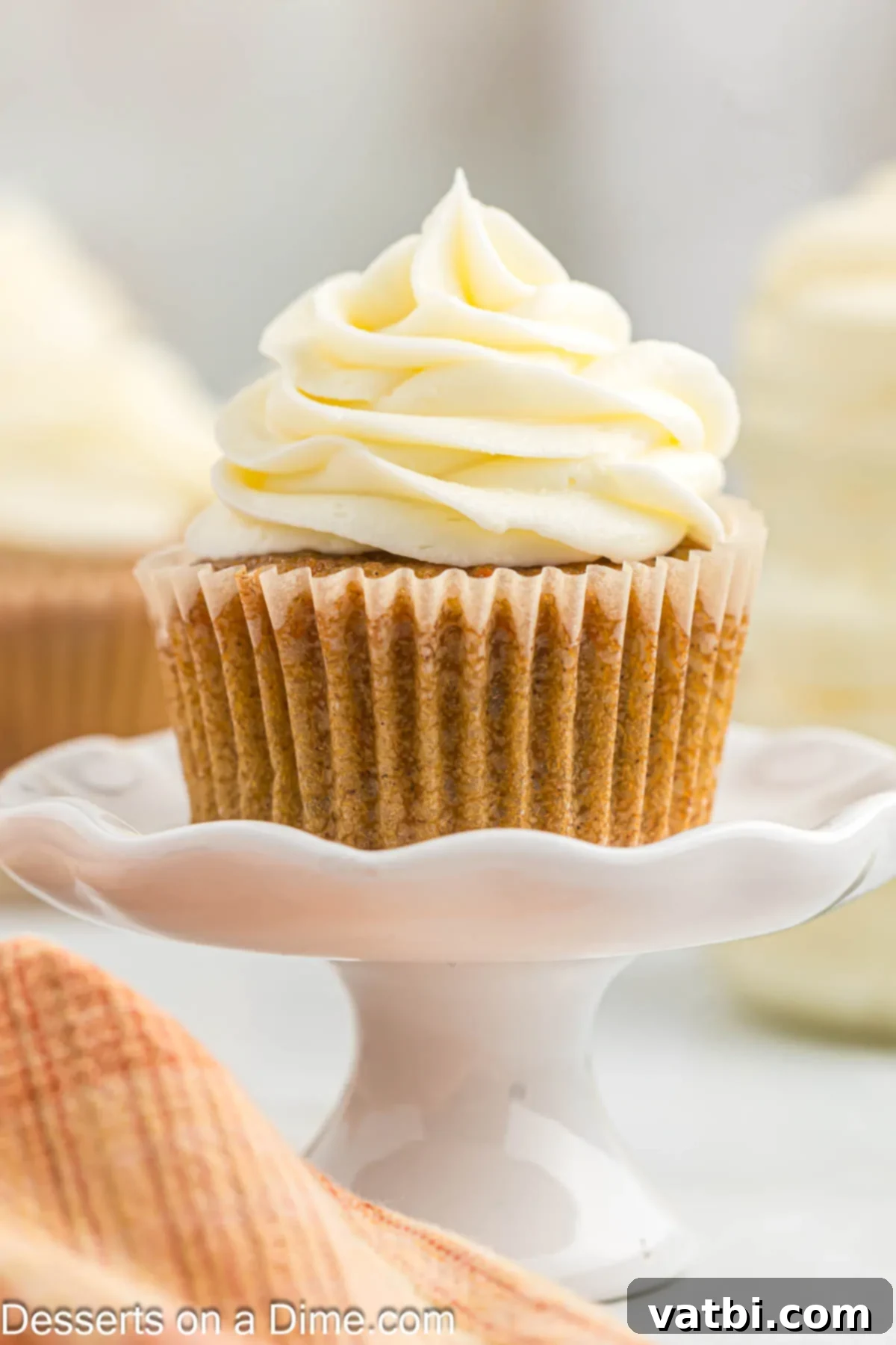 Easy Homemade Cream Cheese Frosting 7 Cupcake with frosting on stand.