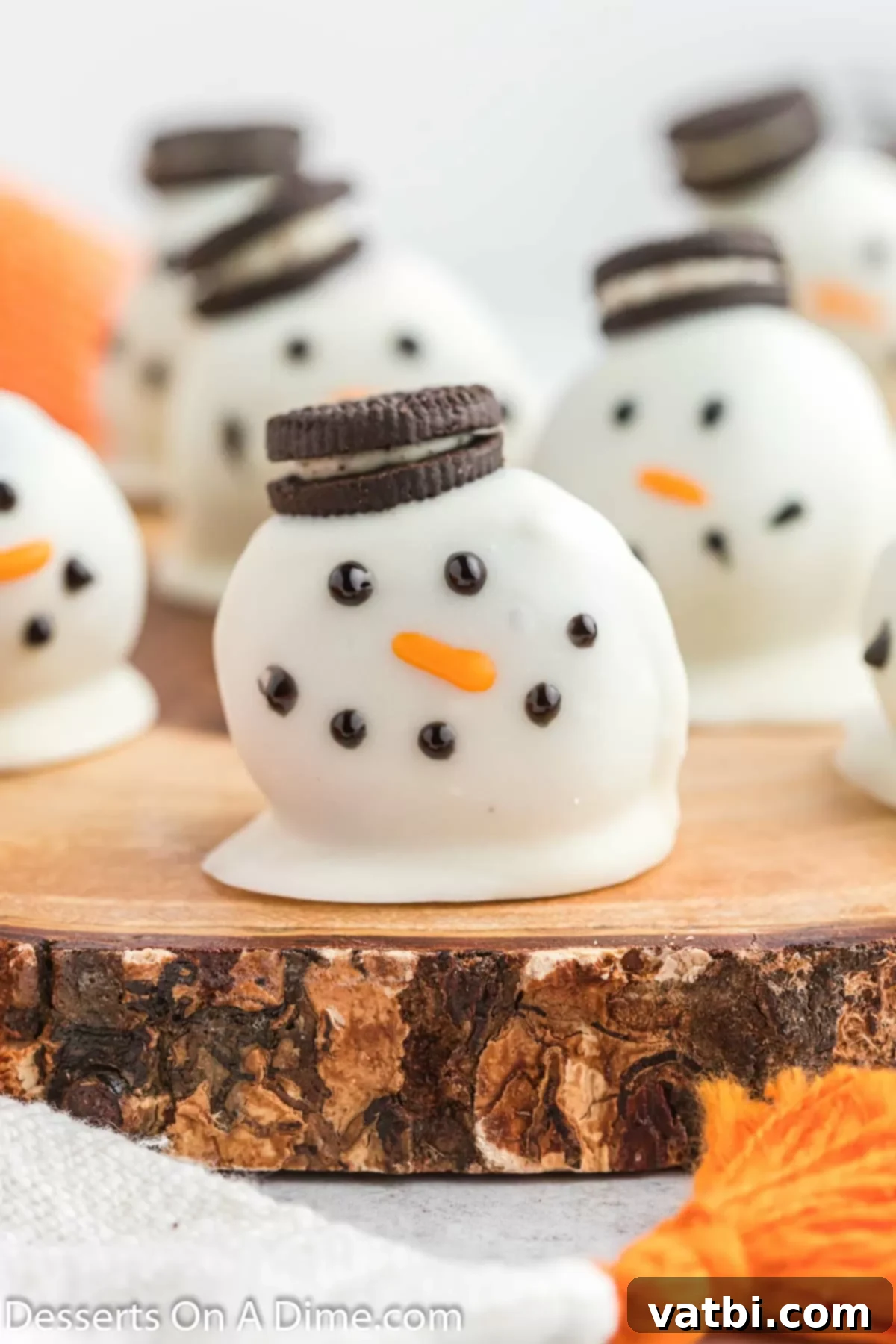 Whimsical Winter Oreo Bites 10 A cluster of decorated Snowman Oreo Balls, showcasing their festive and adorable details.