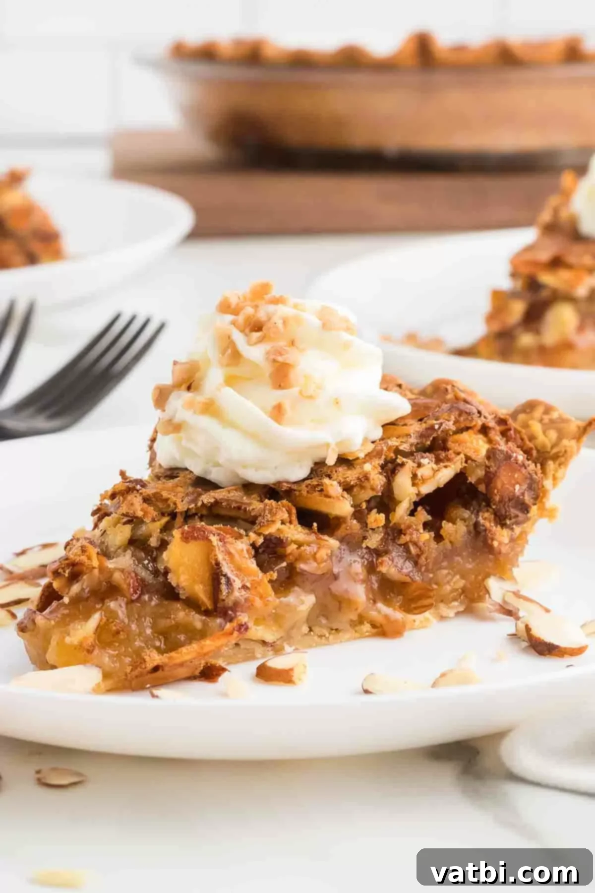 Rich Toffee Almond Indulgence 11 Slice of Toffee almond Pie topped with whipped cream.