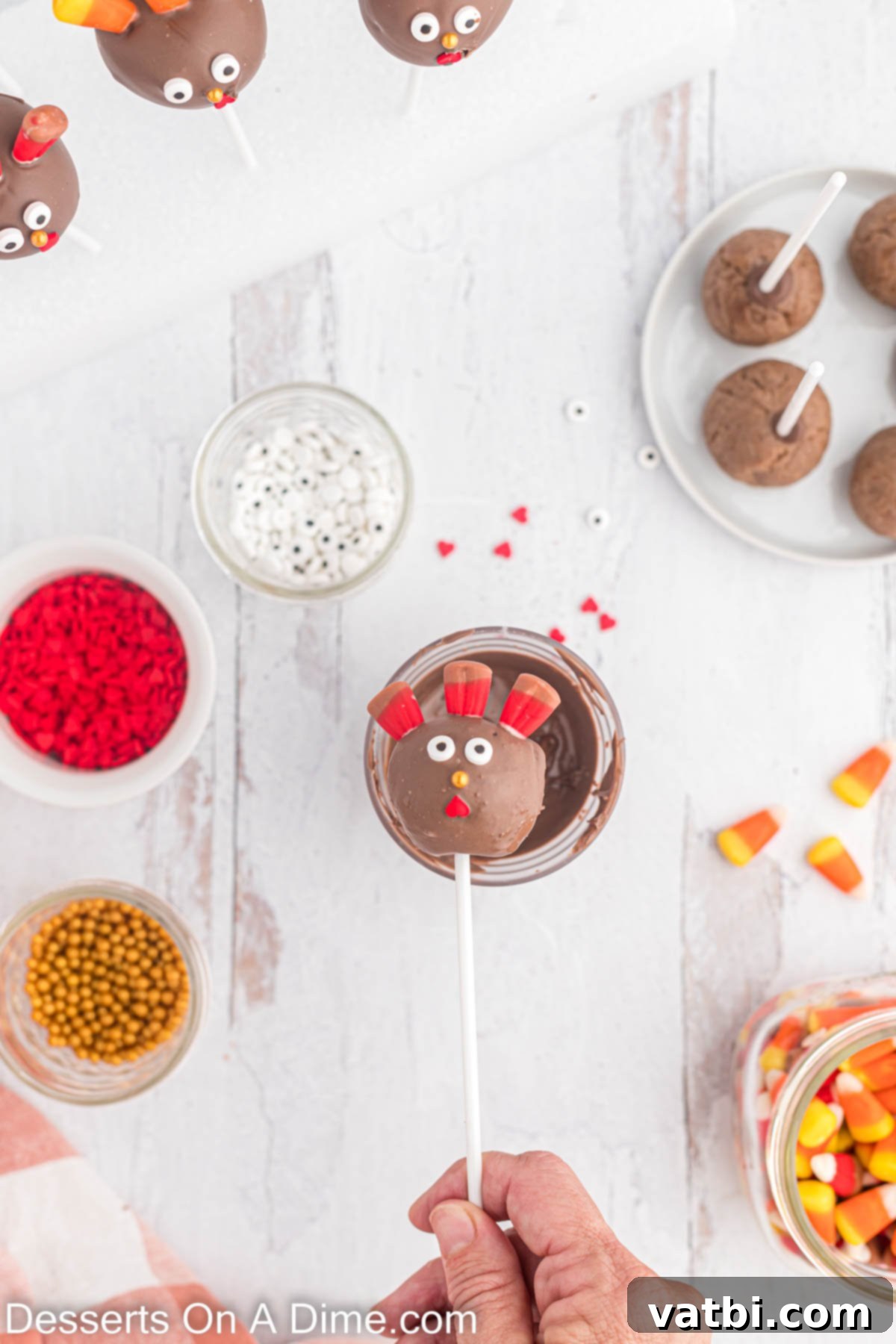 Gobble-Worthy Thanksgiving Cake Pops 9 Cake pops decorated with candy pieces.