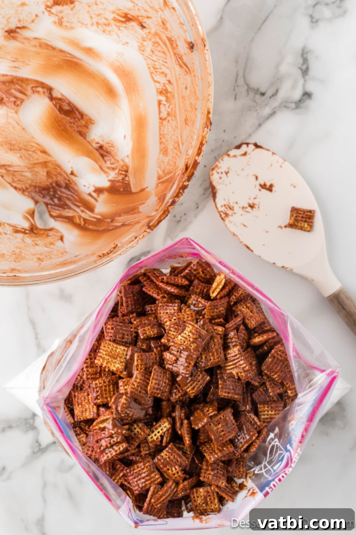 Perfect Harvest Puppy Chow Recipe 9 Cereal in a Ziplock bag coated in chocolate and powdered sugar.