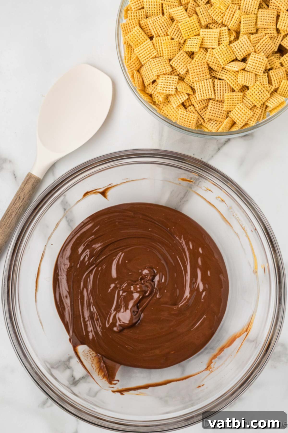 Decadent Brownie Muddy Buddies 5 Melted chocolate and peanut butter mixture in a bowl, smooth and glossy.