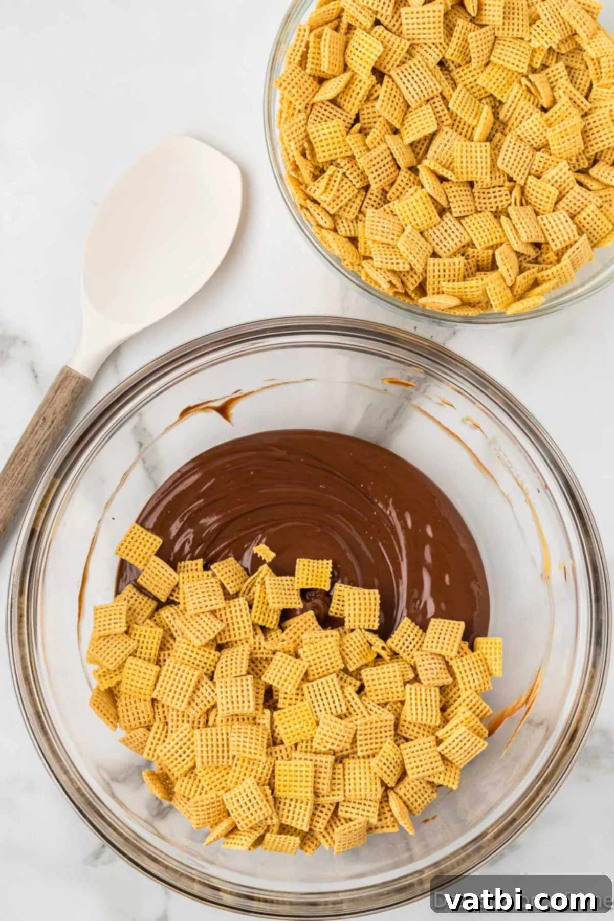 Decadent Brownie Muddy Buddies 6 Chex cereal being poured into the melted chocolate and peanut butter mixture.