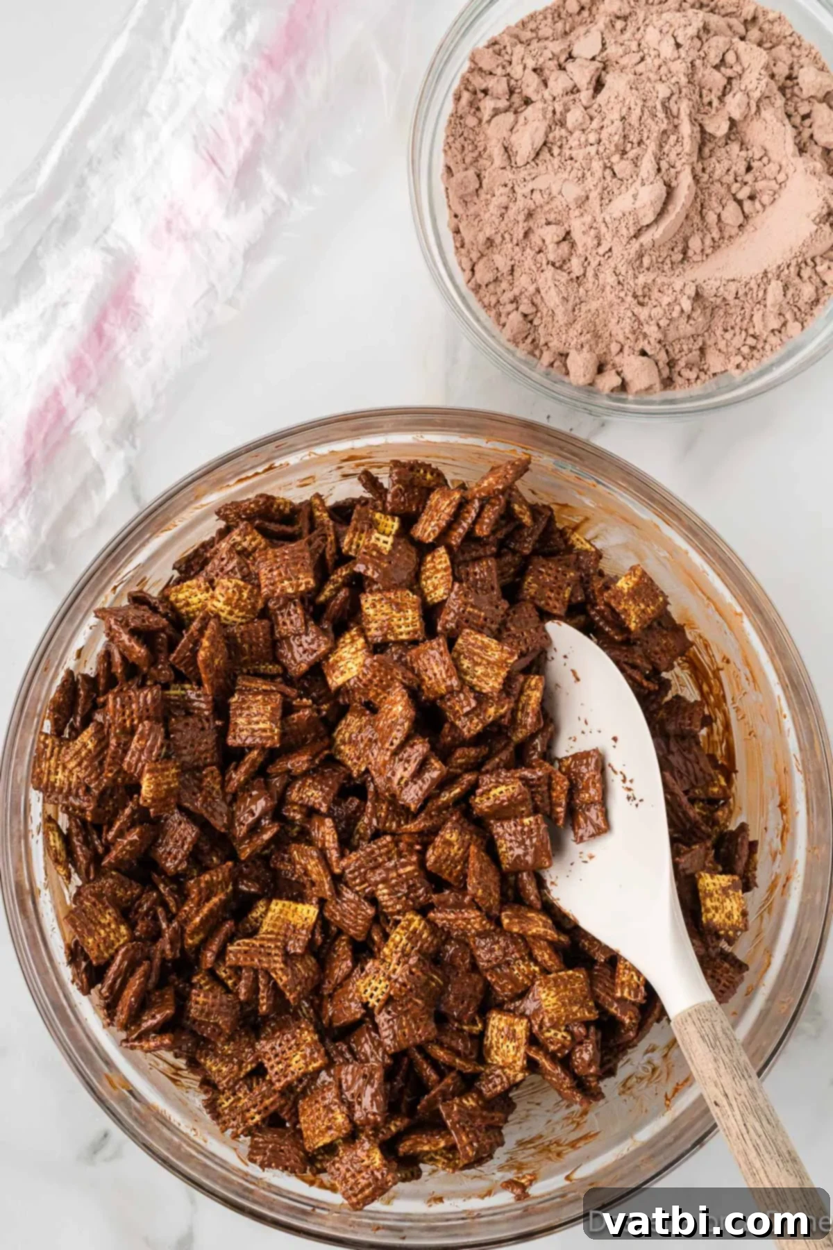 Decadent Brownie Muddy Buddies 7 The Chex cereal thoroughly coated with the chocolate and peanut butter mixture.