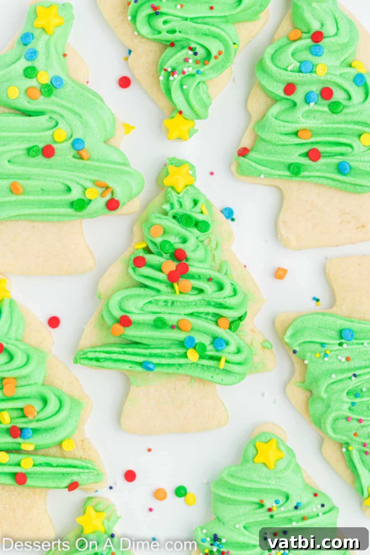 Festive Christmas Tree Sugar Cookies 2 Christmas Tree Sugar Cookies arranged beautifully on a serving platter, decorated with vibrant green frosting and colorful sprinkles, embodying holiday cheer.