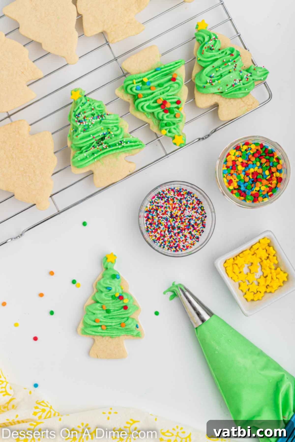 Festive Christmas Tree Sugar Cookies 11 Beautifully frosted Christmas tree sugar cookies, adorned with expertly piped green cream cheese frosting and an assortment of festive sprinkles, arranged for display.