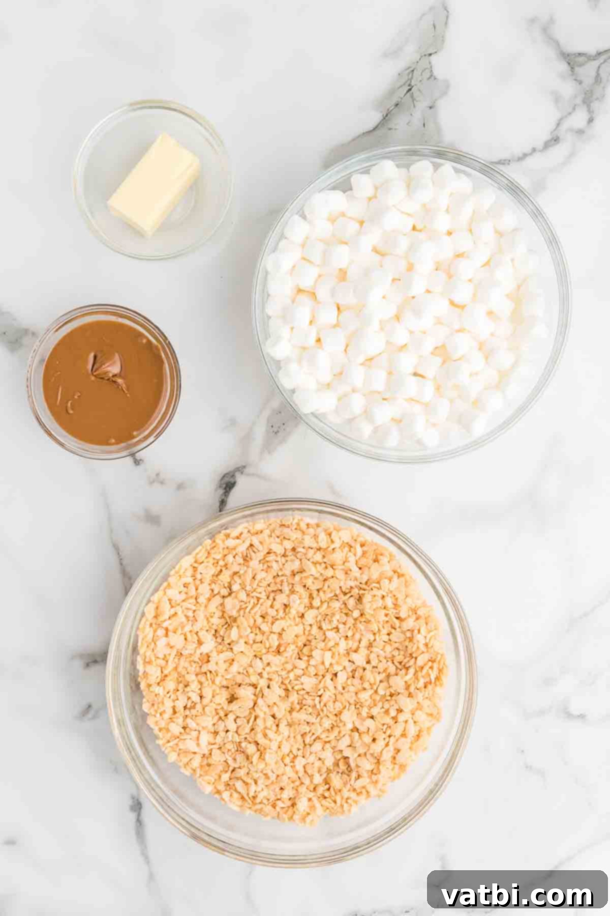 Speculoos Krispie Delights 3 Ingredients for Cookie butter rice krispie treats - rice krispie cereal, butter, marshmallows and cookie butter.