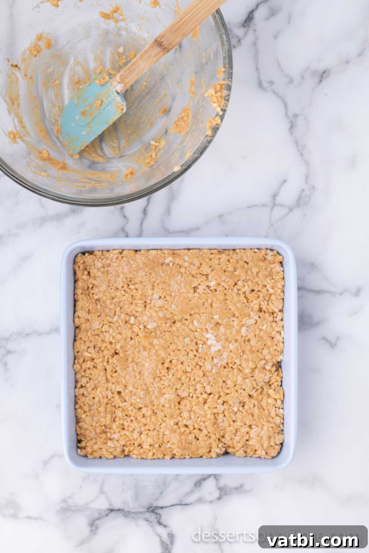 Speculoos Krispie Delights 6 Mixture spread into pan.