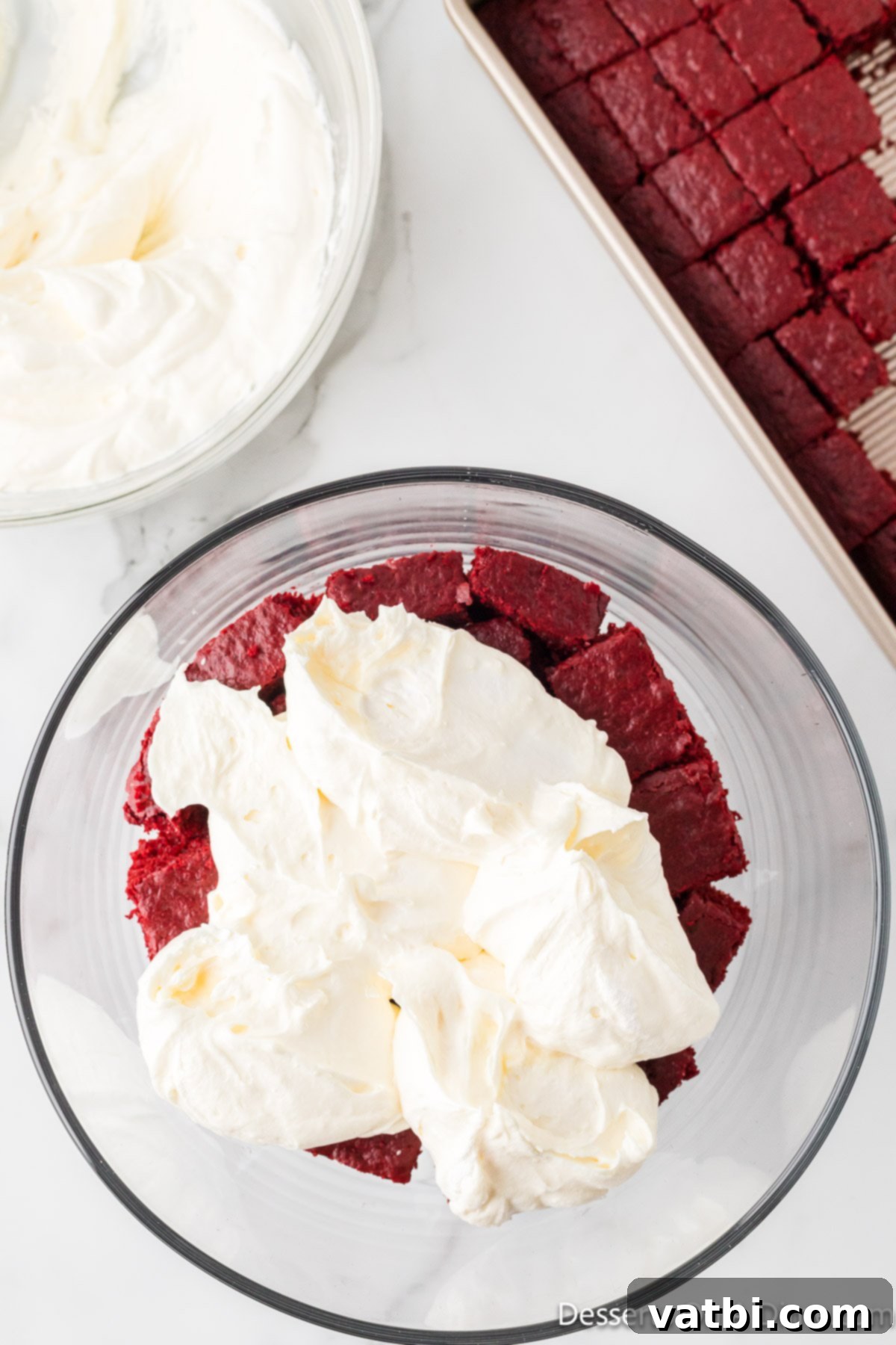 Crimson Velvet Trifle 13 First layer of cream cheese mixture spread evenly over the cake cubes.