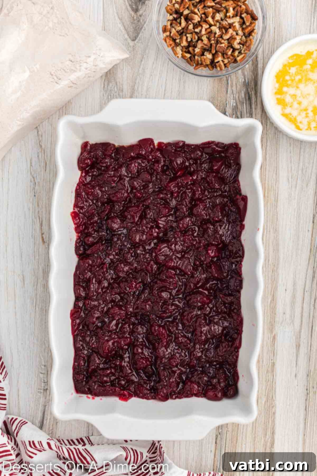 Holiday Dump Cake Delight 4 Cranberry sauce in baking dish.