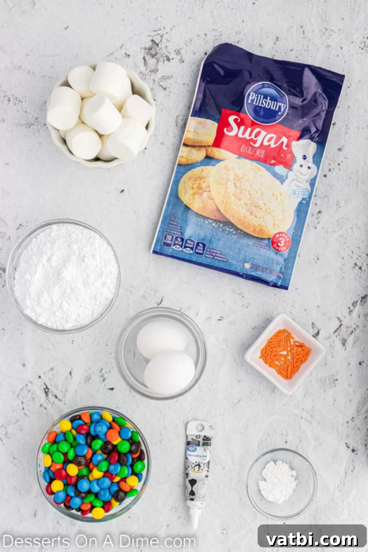 Adorable Melted Snowman Cookies 3 Ingredients for melted snowman cookies - sugar cookie mix, marshmallows, sprinkles, M&Ms, black decorating gel.