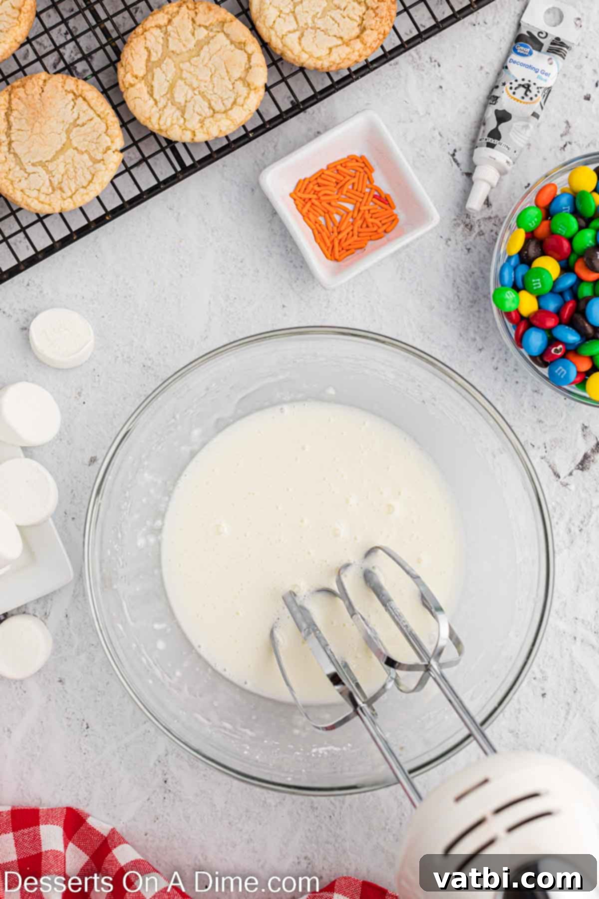 Adorable Melted Snowman Cookies 4 Bowl with icing being combined.