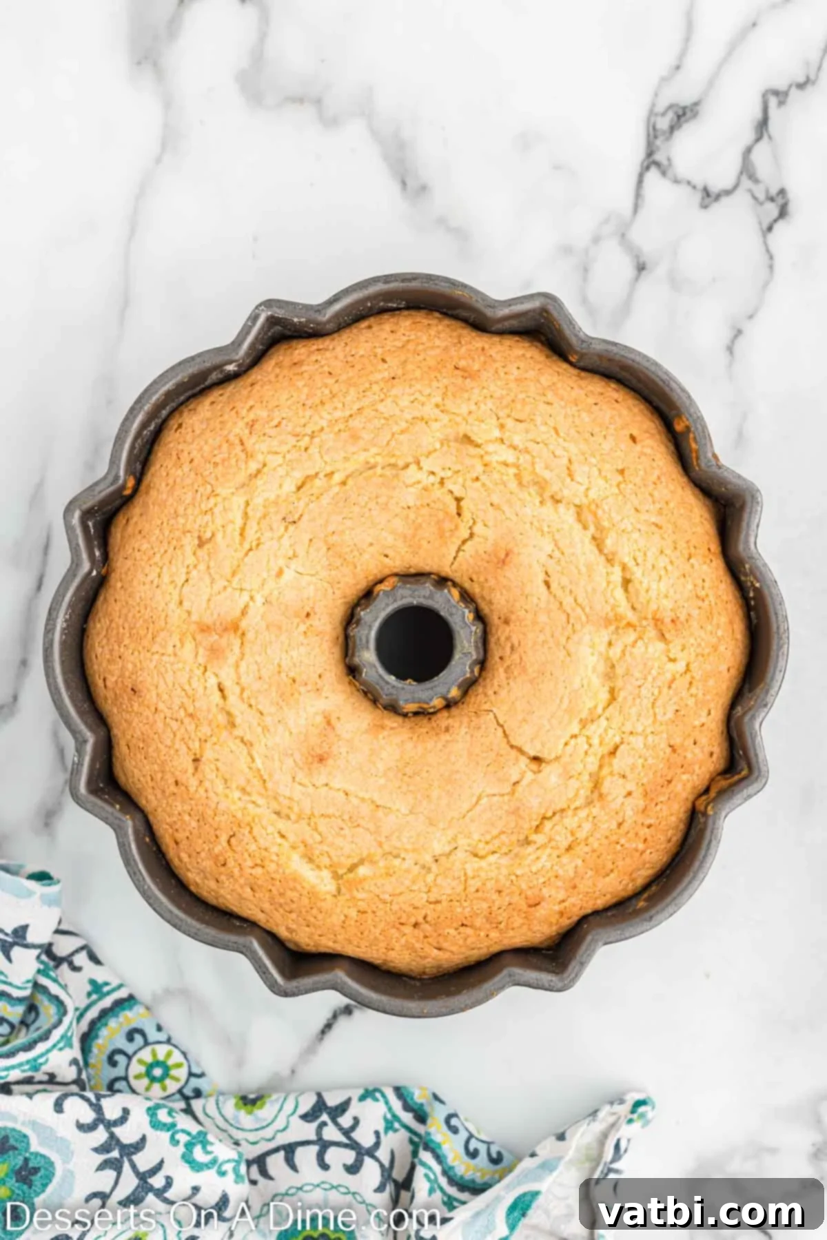 Baked lemon pound cake cooling inside the bundt pan before being inverted.