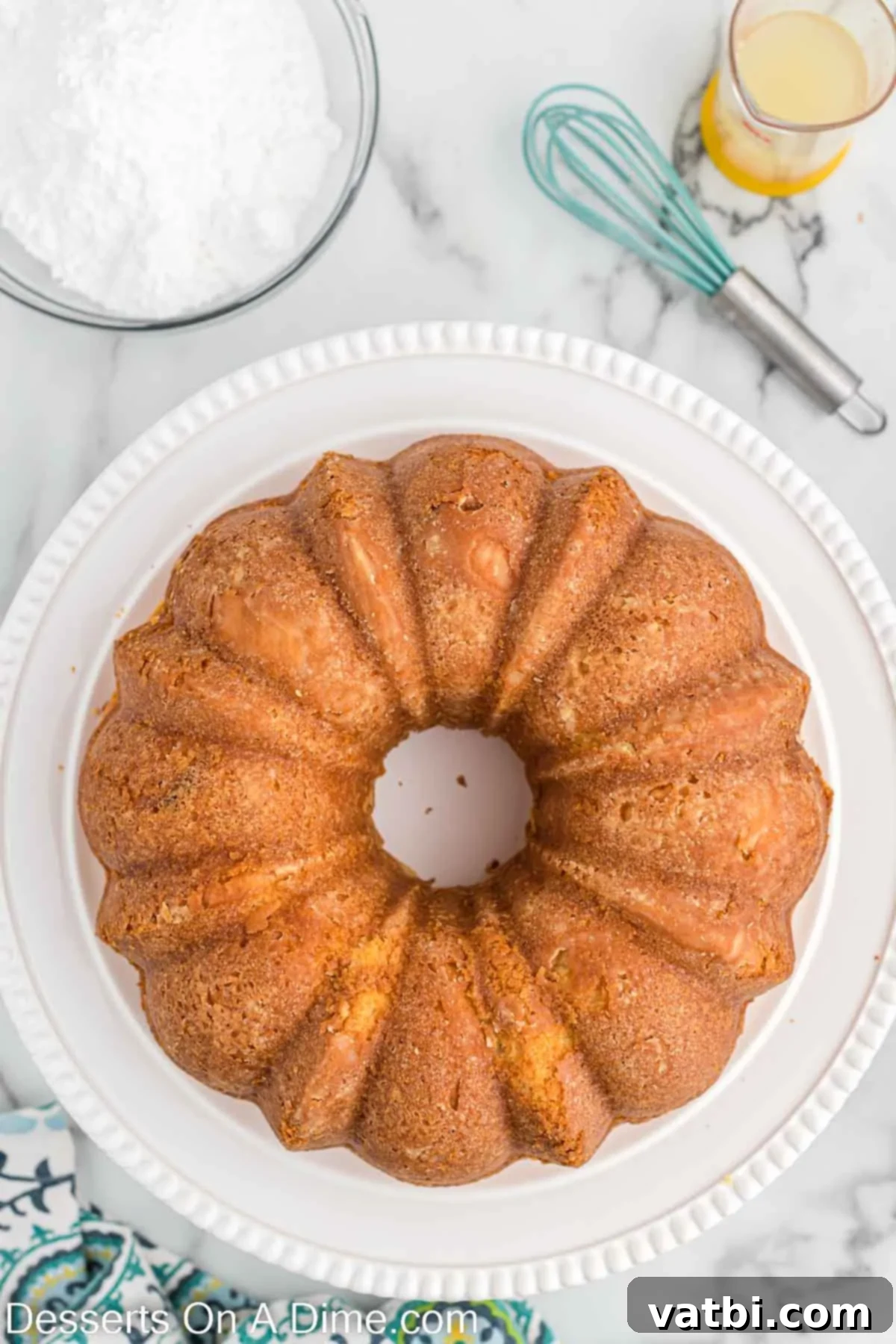 A perfectly inverted and cooled lemon pound cake resting on a serving platter, ready for glaze.