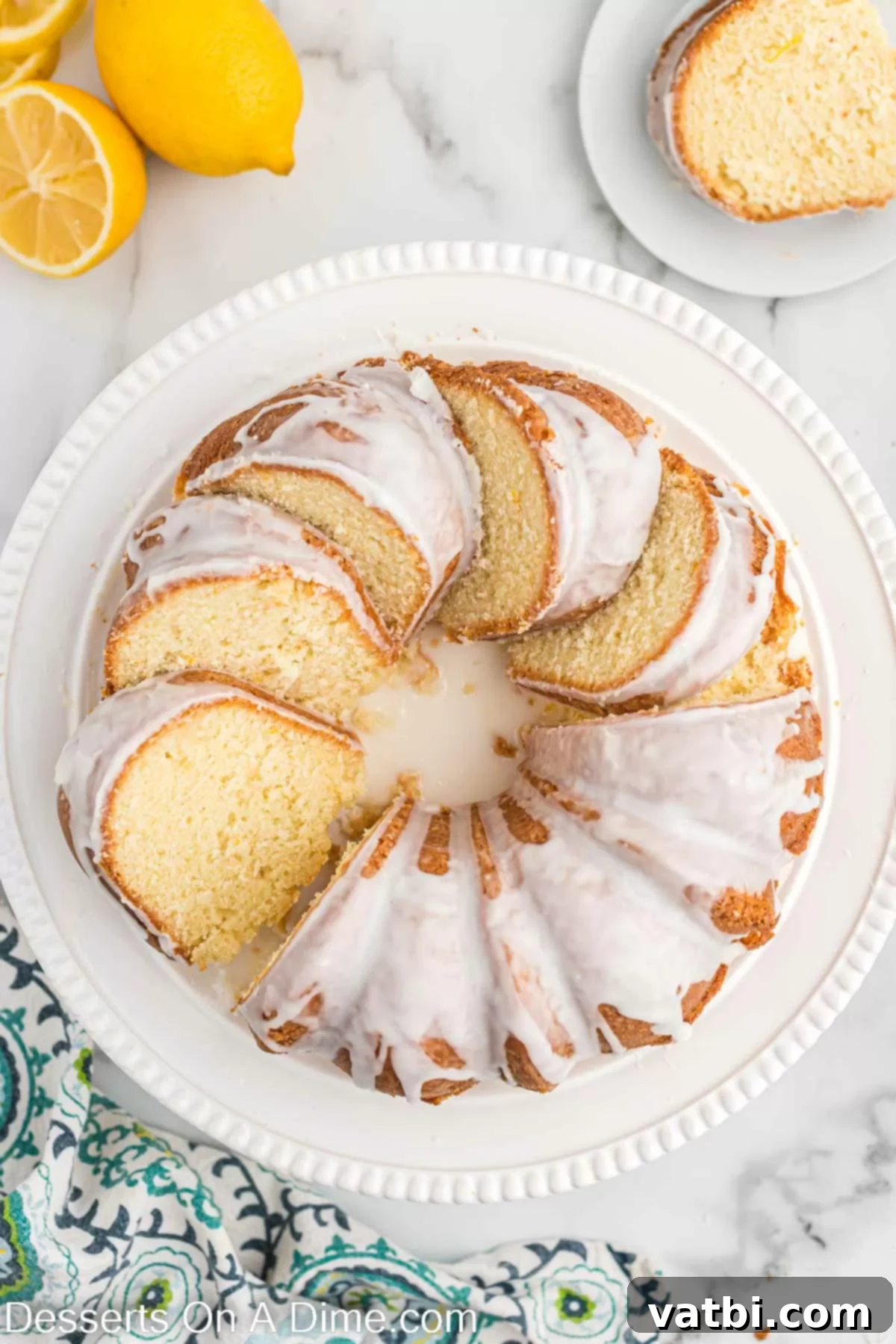 A close-up of a perfectly sliced lemon pound cake, revealing its tender, moist interior and delicious glaze.