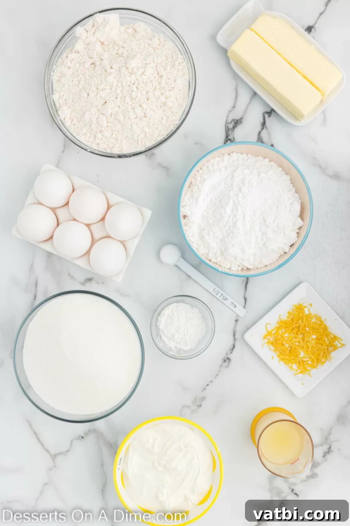 Key ingredients for a delicious lemon pound cake including flour, butter, eggs, sour cream, fresh lemon juice, lemon zest, and powdered sugar for the glaze.