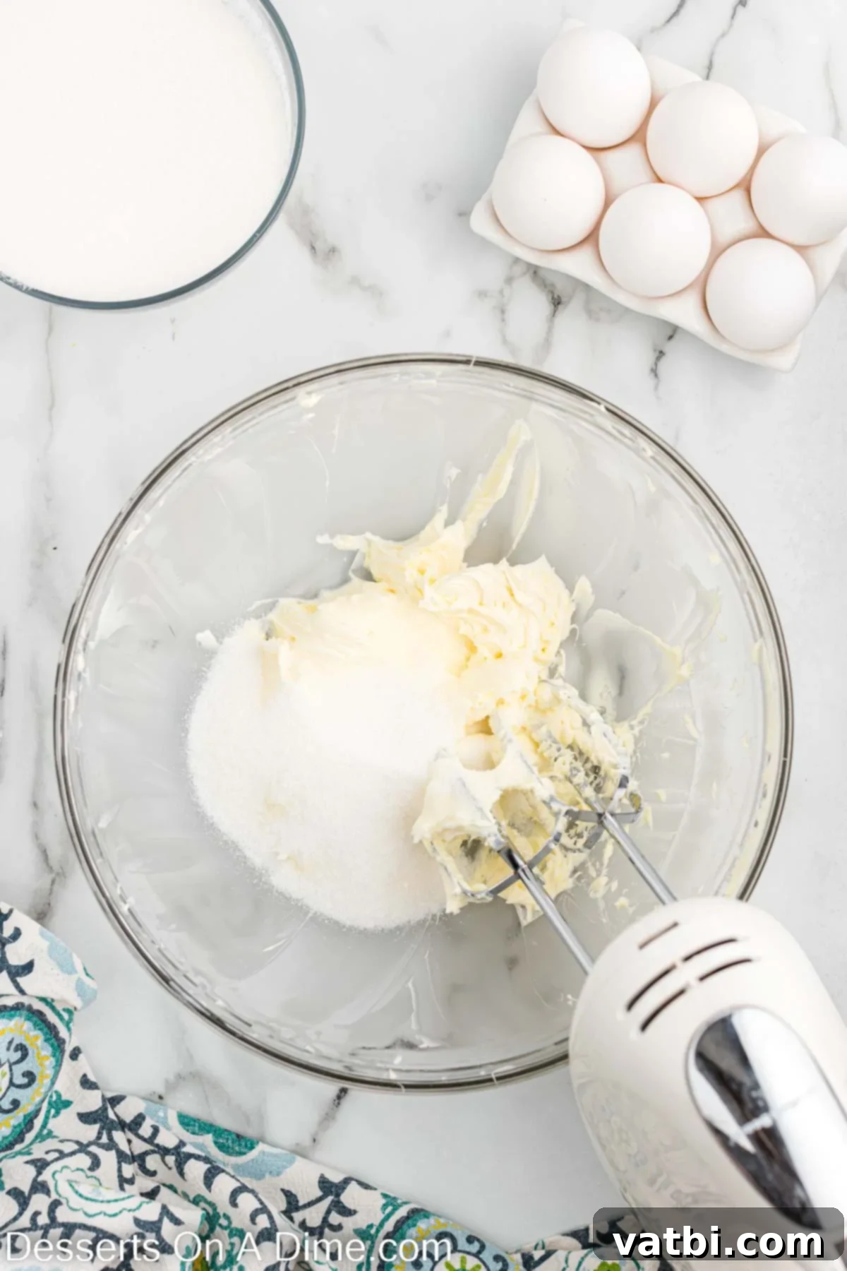 Granulated sugar slowly added to the creamed butter, mixing until smooth.