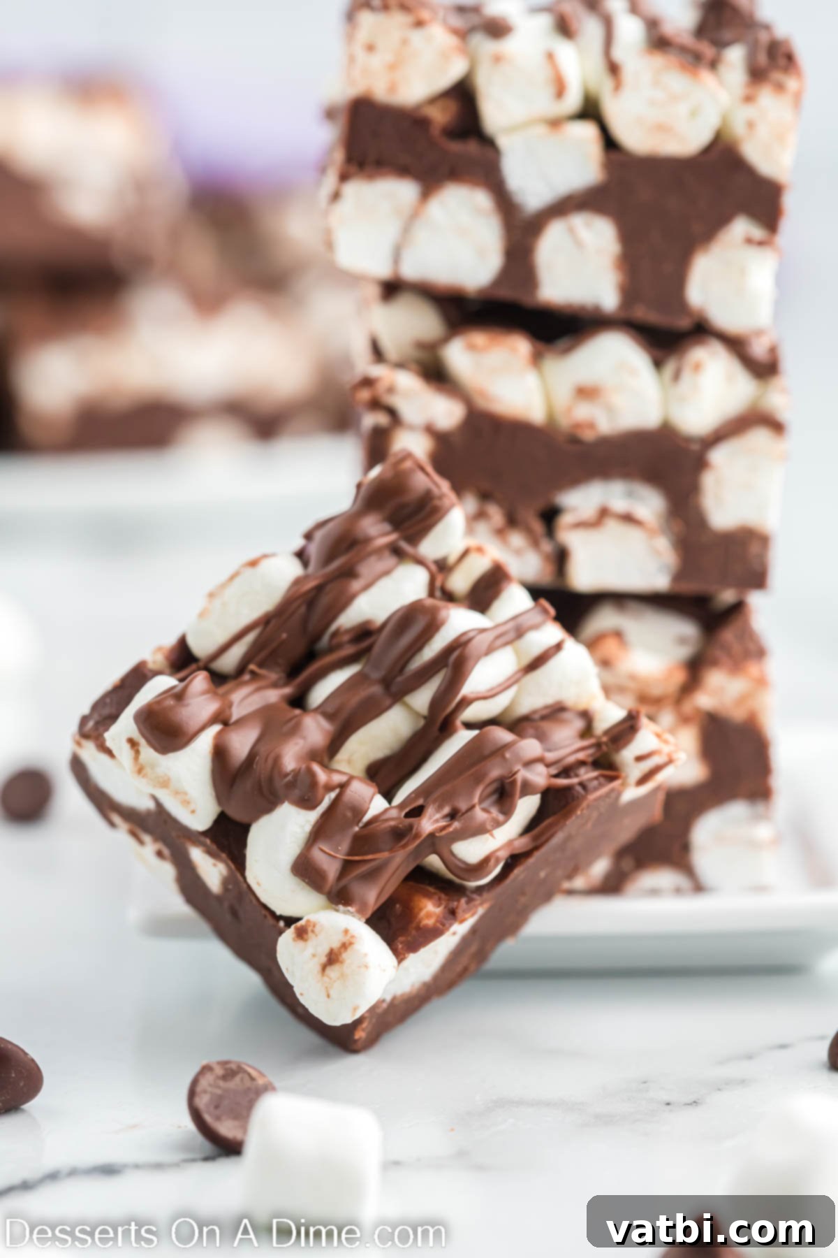 Decadent Hot Chocolate Fudge 2 Hot chocolate fudge cut into perfect squares, topped with mini marshmallows and a chocolate drizzle.