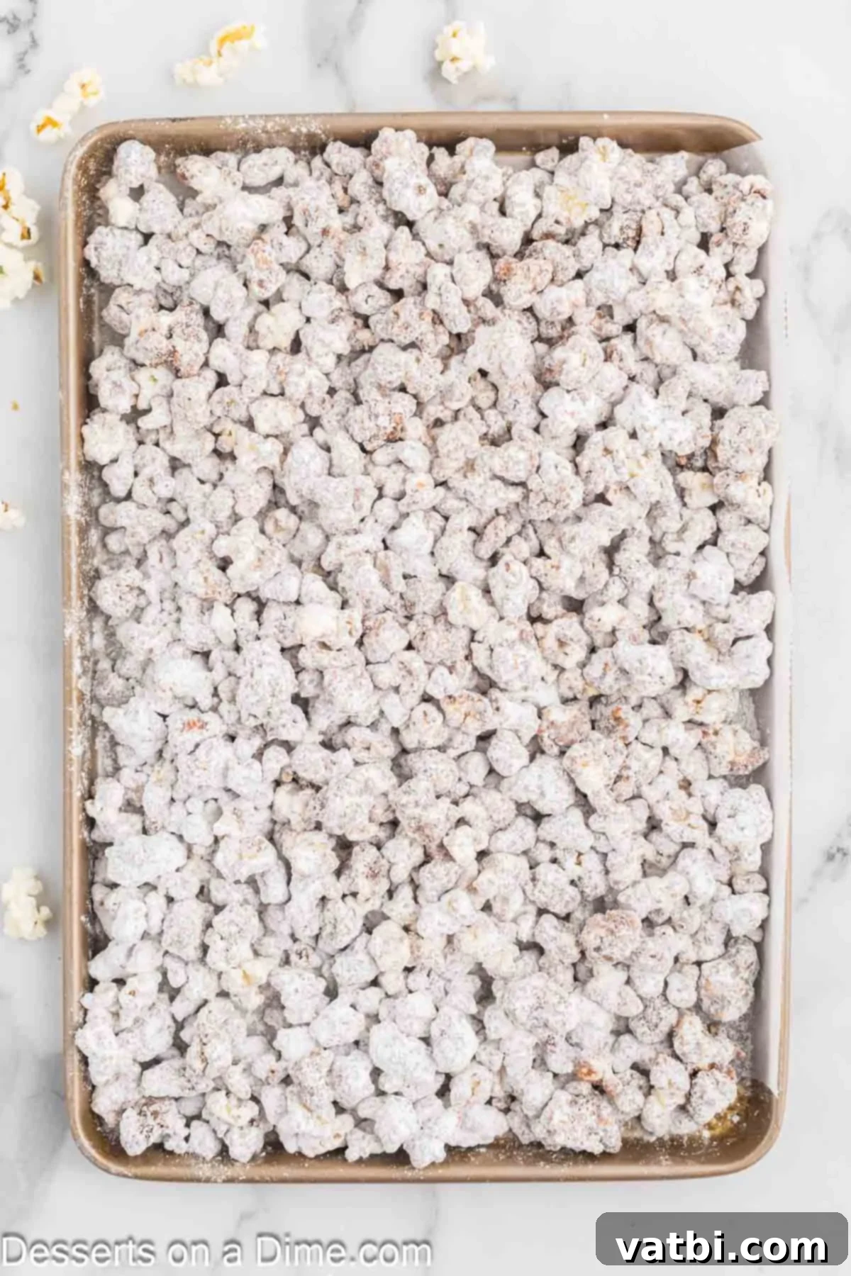 Muddy Buddies Popcorn 6 Chocolate-coated popcorn being shaken in a large resealable bag with powdered sugar, then spread on a baking sheet.