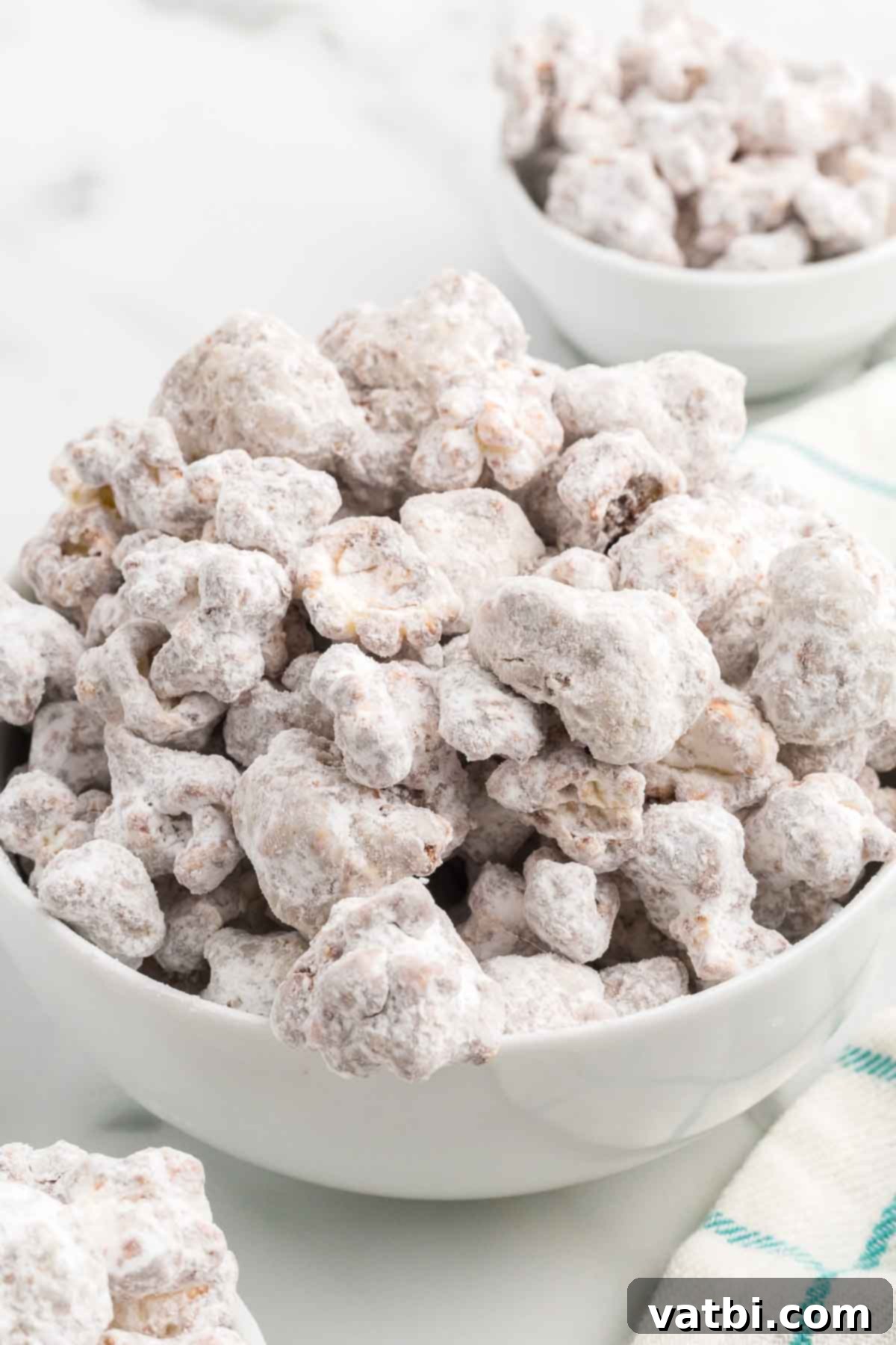 Muddy Buddies Popcorn 7 Finished Puppy Chow Popcorn in a serving bowl, ready to be enjoyed.