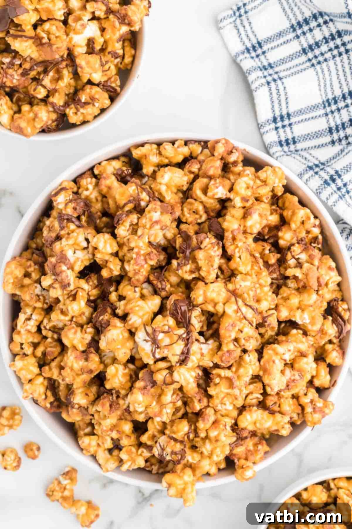 Snickers Popcorn Crunch 10 A large bowl filled with delicious Snickers popcorn, ready to be enjoyed.