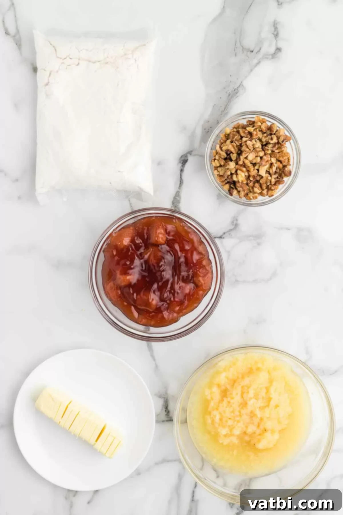 Decadent Banana Split Dump Cake 3 Ingredients for Banana split dump cake - strawberry pie filling, crushed pineapple, white cake mix, butter, walnuts, bananas, chocolate syrup, ice cream, whipped topping, cherries, sprinkles.