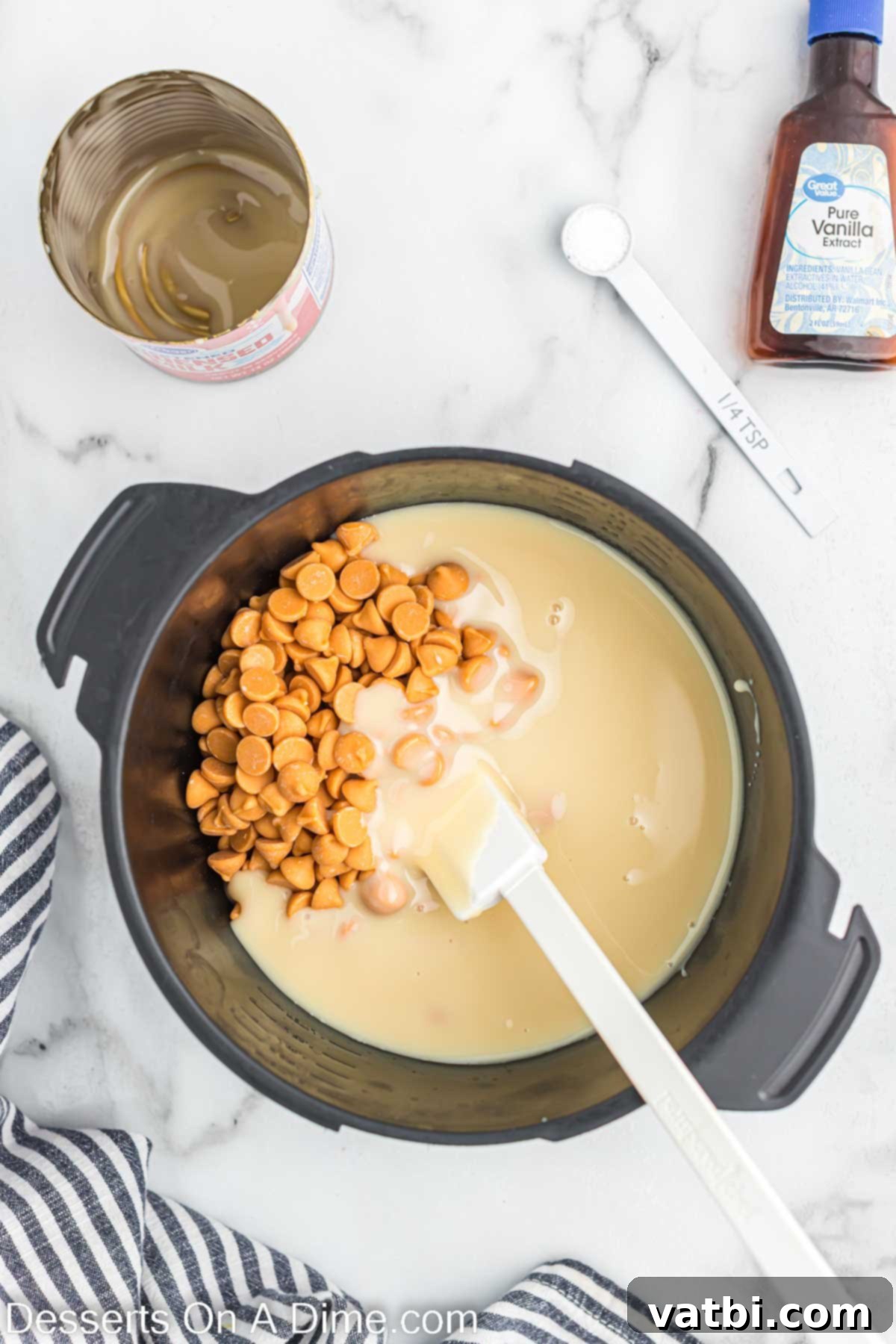 Luscious Butterscotch Dream 4 Butterscotch chips being stirred into sweetened condensed milk in a bowl.