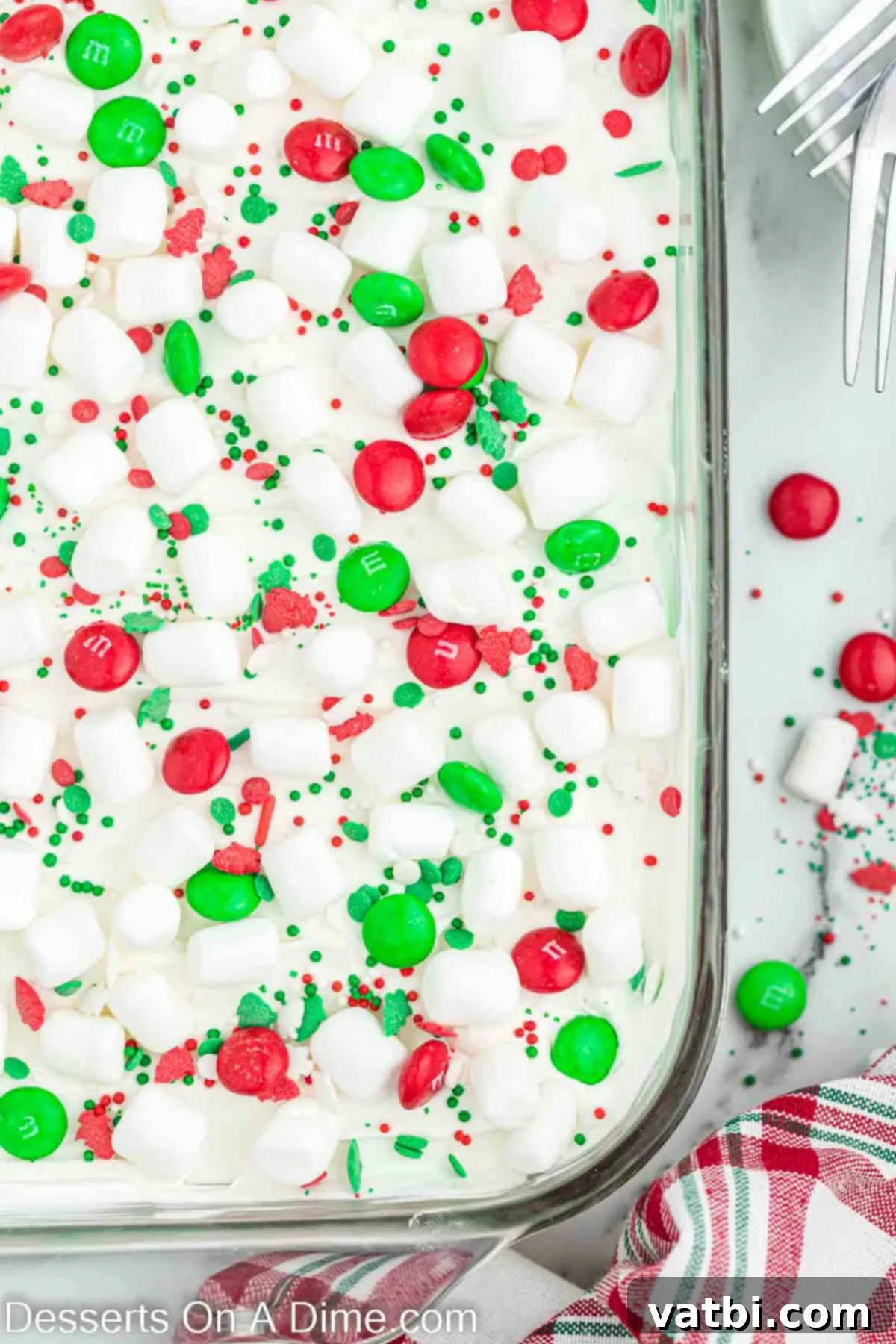 Christmas Layered Dream Dessert 9 The finished Christmas Dessert Lasagna topped with mini marshmallows, Christmas sprinkles, and red and green M&Ms, ready for serving.
