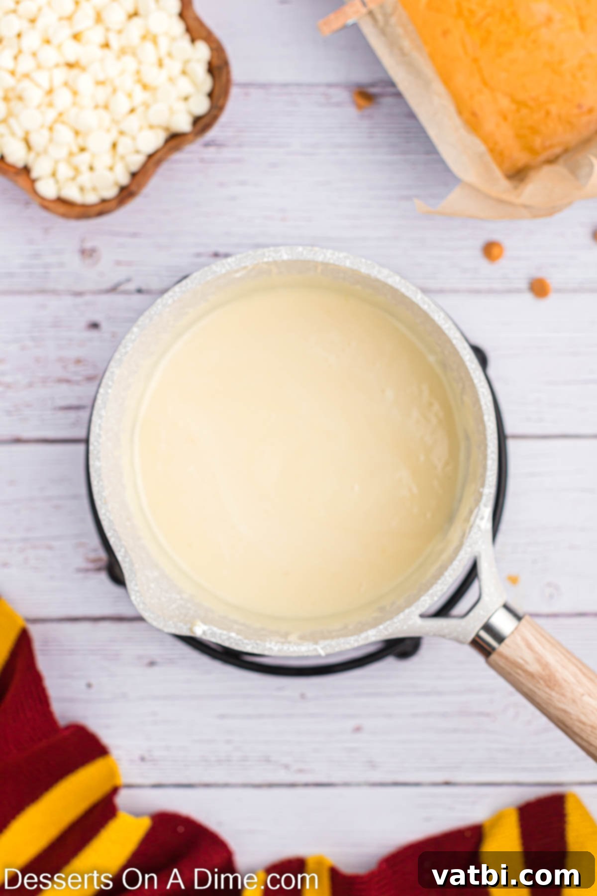 Magical Butterbeer Fudge 9 The combined white chocolate and vanilla mixture, now smooth and well-melted after stirring, showcasing a glossy and thick consistency.