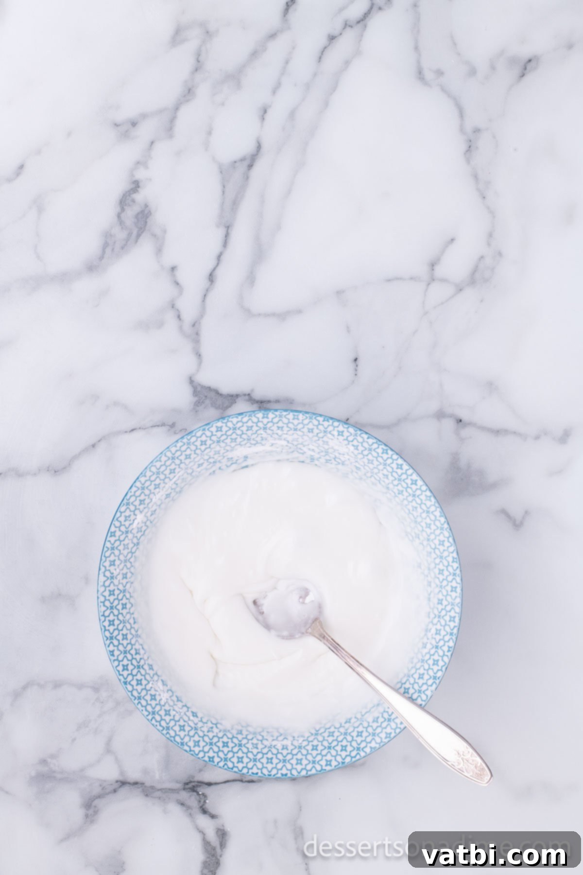 Pop the Sweetness: Krispy Kreme Donut Holes 17 A bowl of freshly prepared glaze, perfectly smooth and ready to coat the warm donut holes.