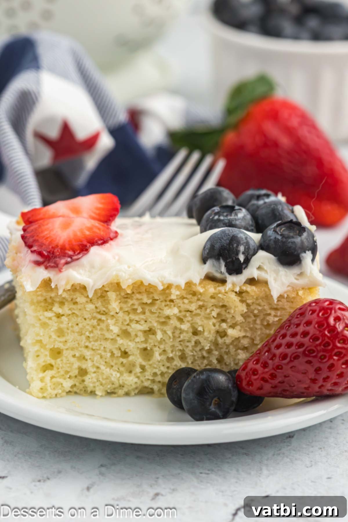 Stars and Stripes Dessert 9 A slice of American Flag Cake served on a white plate.