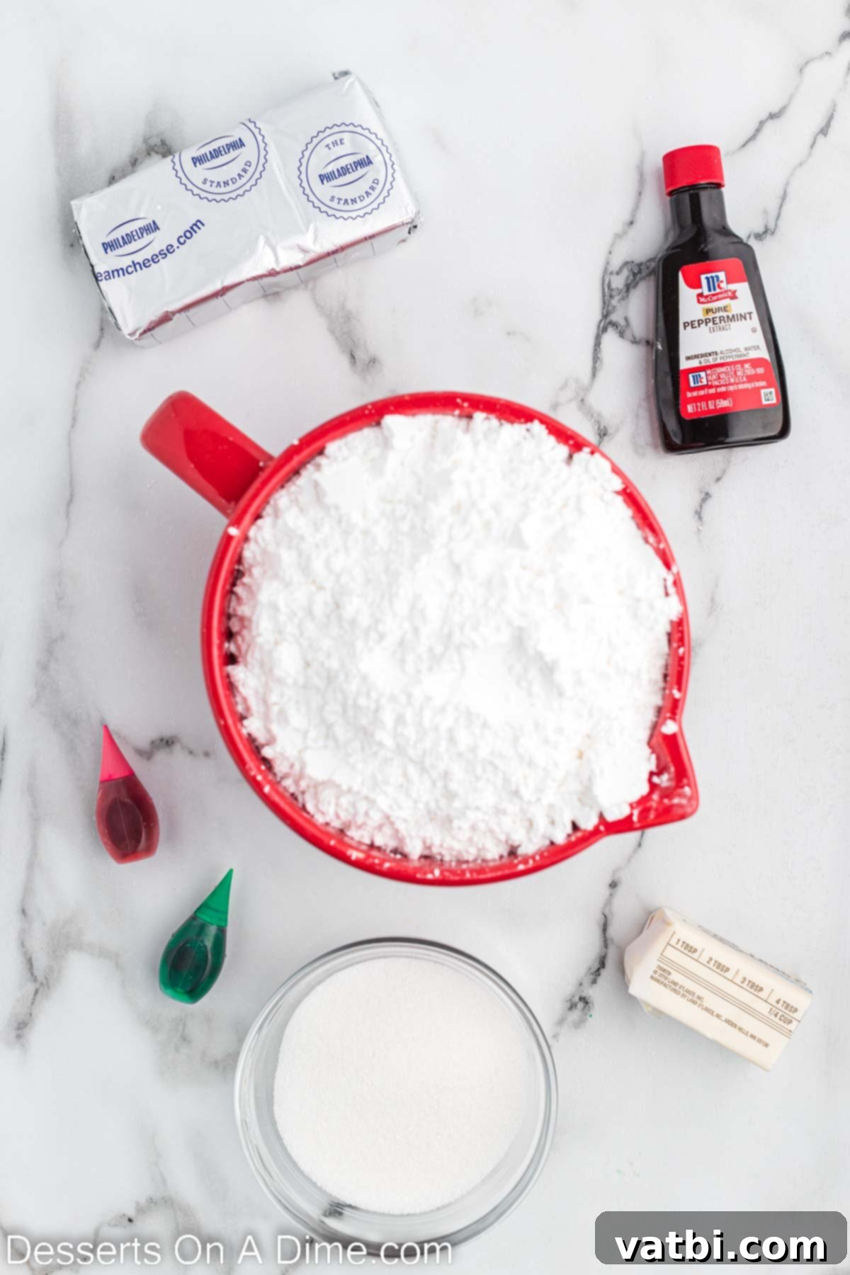 Holiday Mint Magic 3 Ingredients for Christmas mints laid out: cream cheese, powdered sugar, vanilla, food coloring, butter.