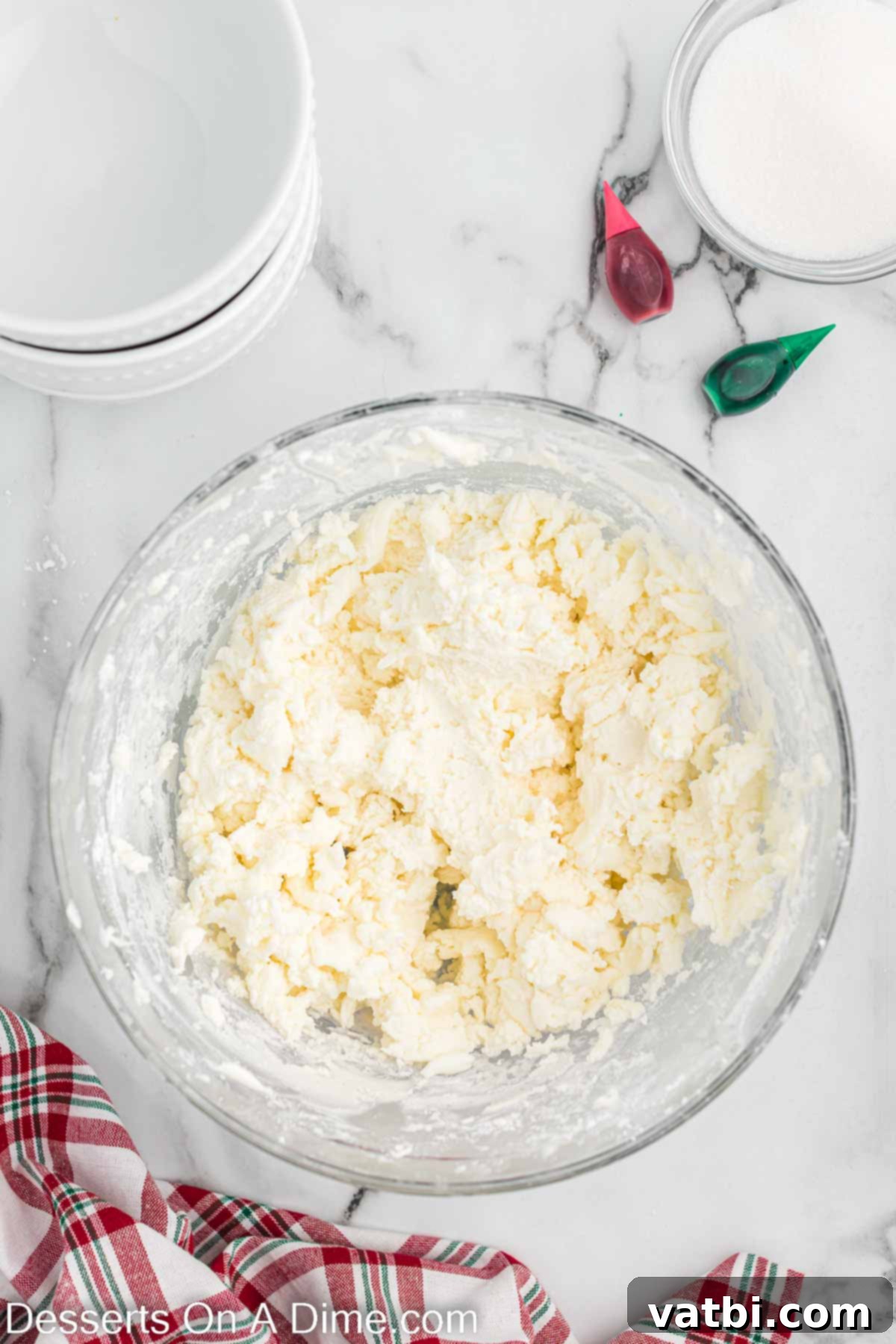 Holiday Mint Magic 5 Powdered sugar being gradually added to the cream cheese and butter mixture.