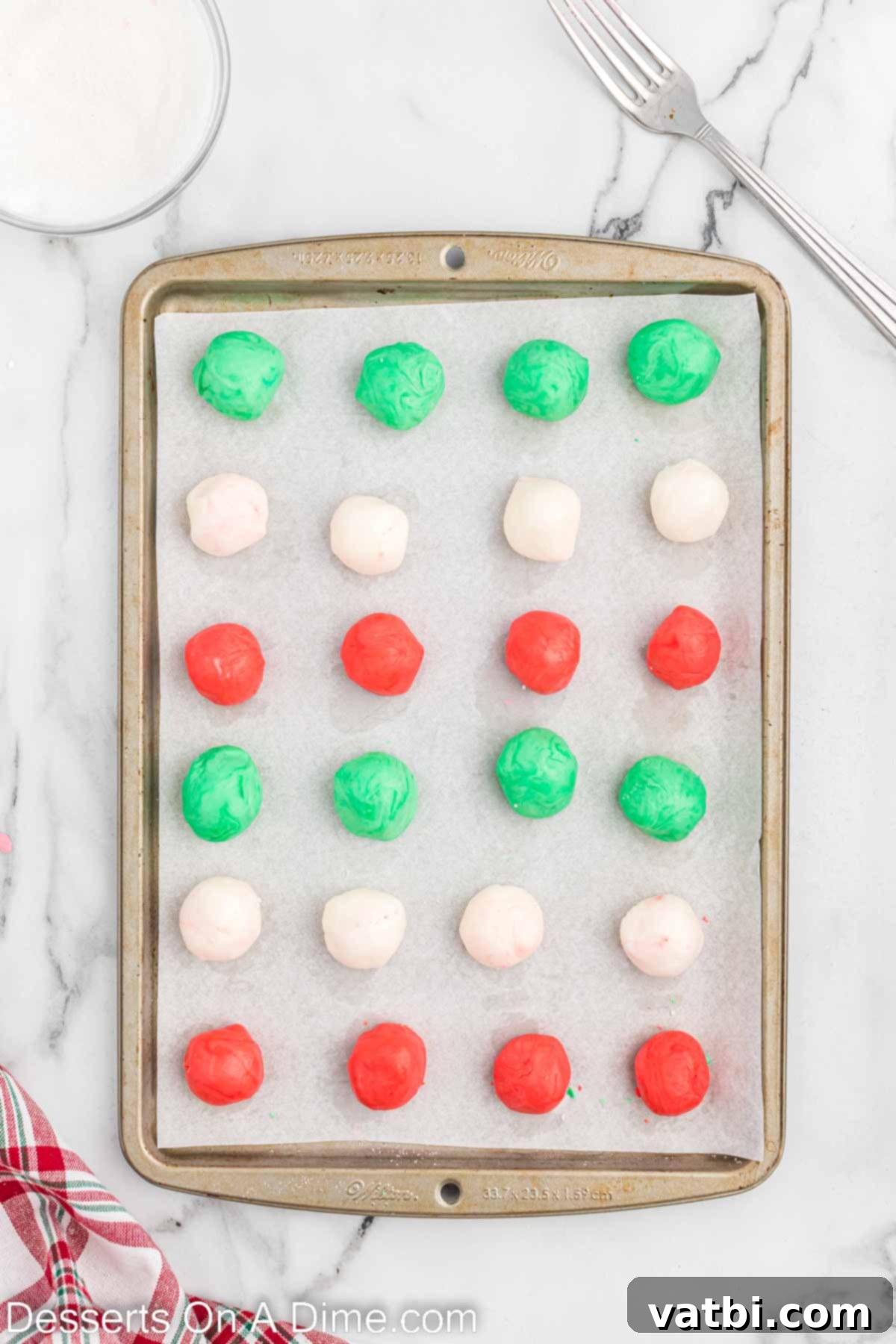Holiday Mint Magic 6 Mints rolled into small balls and neatly arranged on a baking sheet.