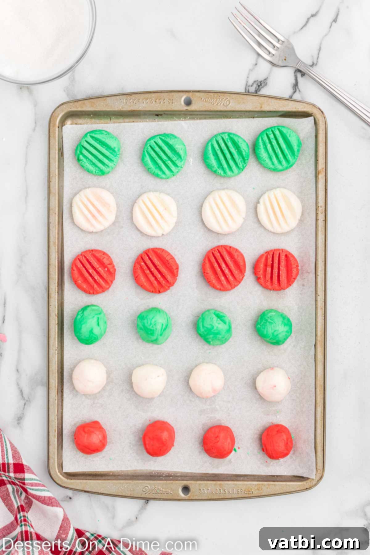 Holiday Mint Magic 7 Mints flattened with a fork, showing a decorative pattern on top.