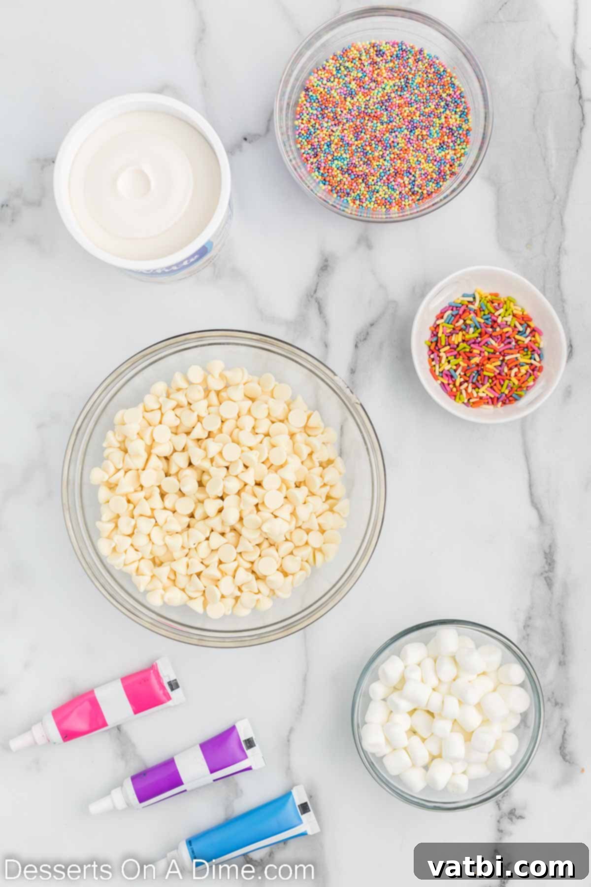 Rainbow Unicorn Fudge 3 Ingredients for Unicorn fudge - white chocolate chips, frosting, food coloring, mini marshmallows, sprinkles.