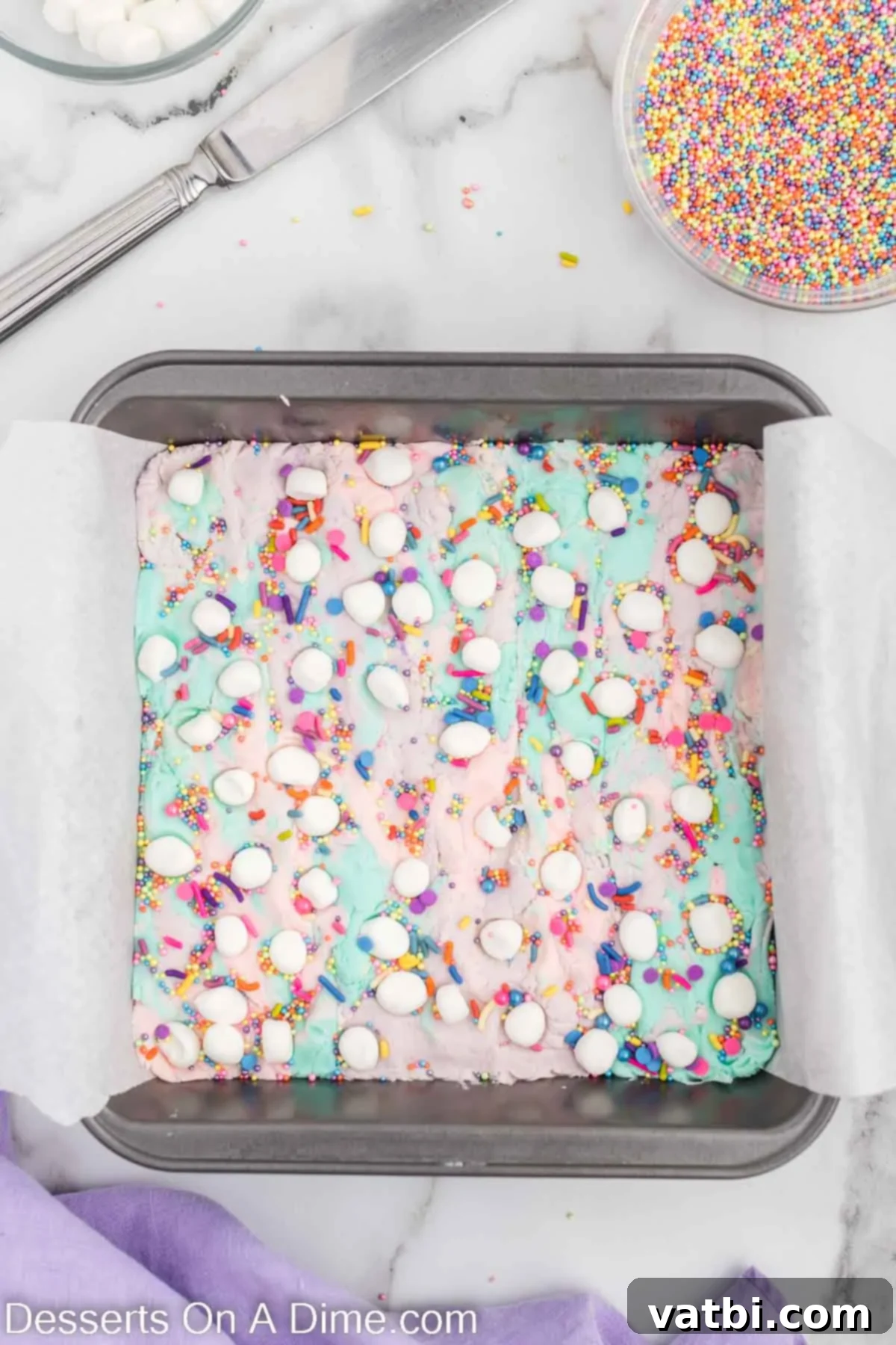 Rainbow Unicorn Fudge 9 Sprinkles and marshmallows topped on fudge.