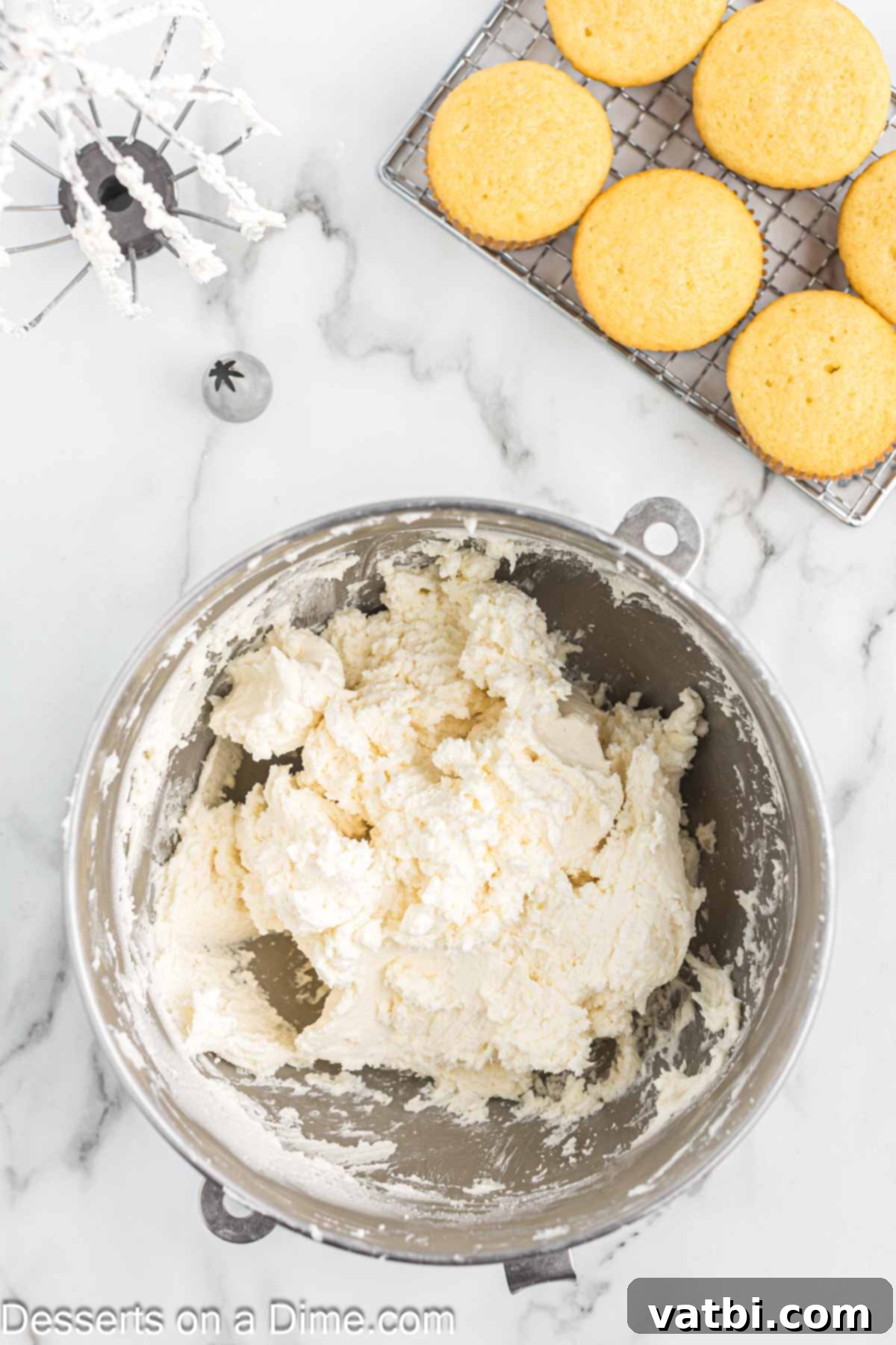 Mixing bowl with powdered sugar added to the mixture. 
