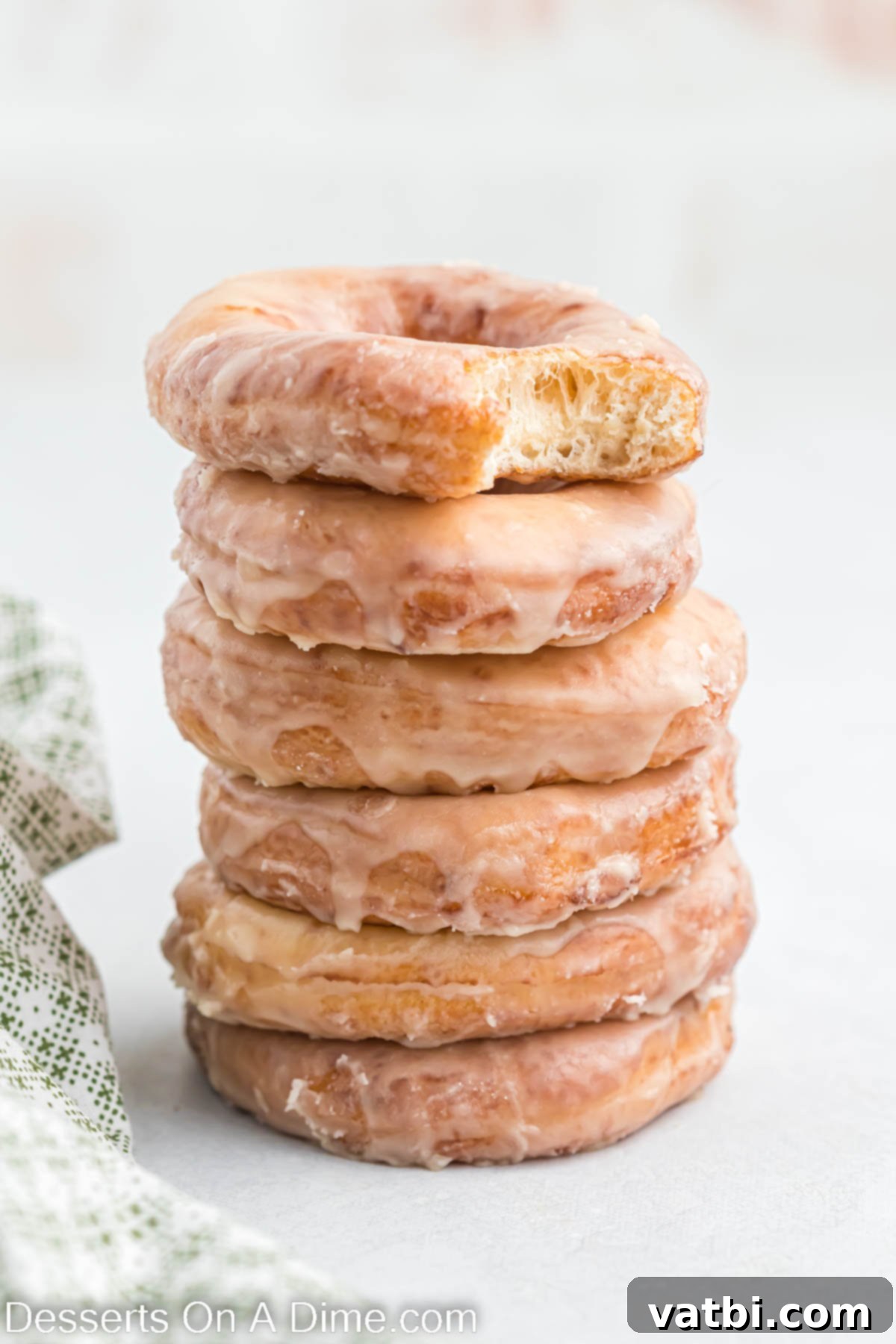 Homemade Krispy Kreme Doughnuts: The Ultimate Guide 2 Krispy Kreme Donuts stacked together, glistening with glaze.
