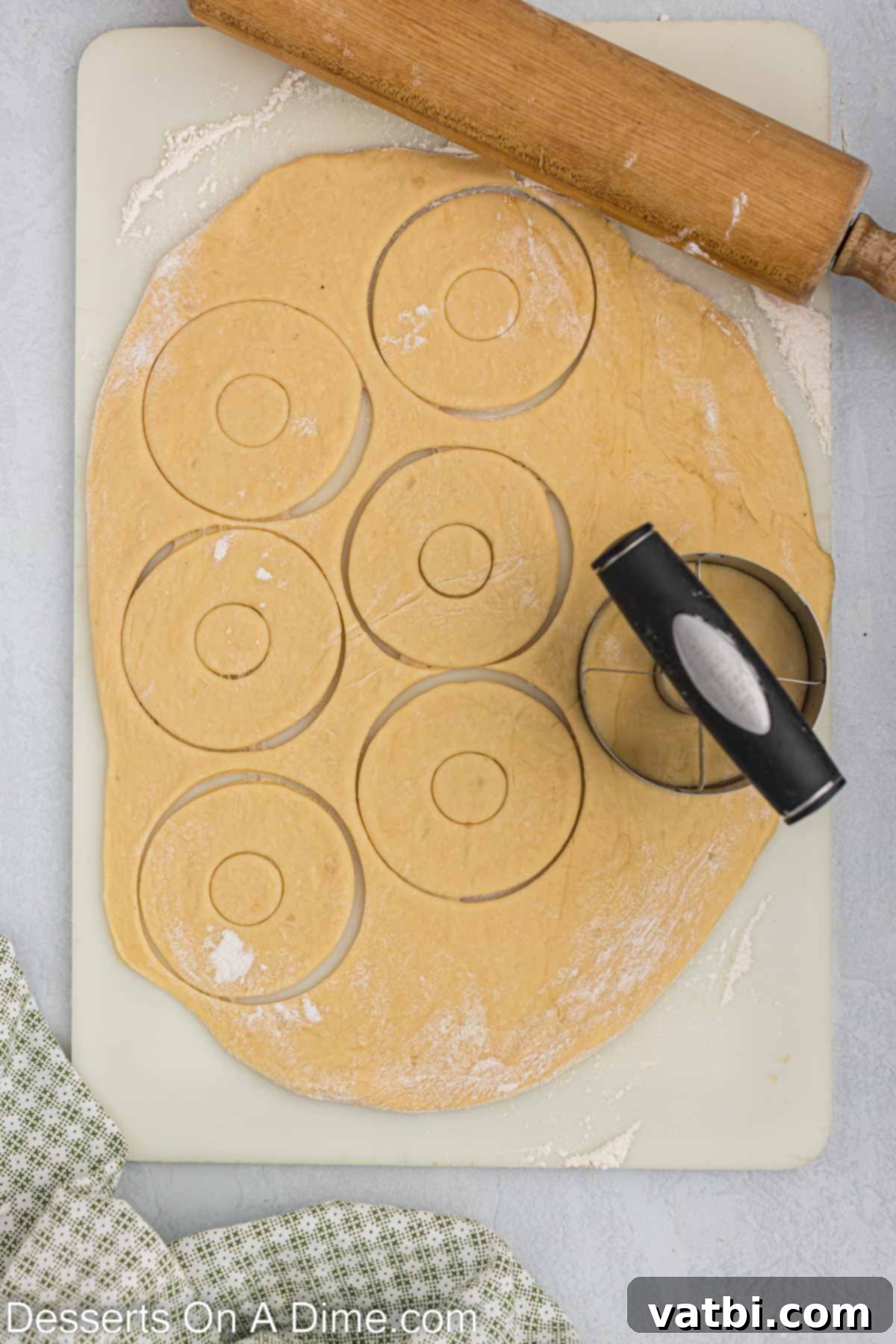 Homemade Krispy Kreme Doughnuts: The Ultimate Guide 11 Doughnut cutter being used to make donut shapes.