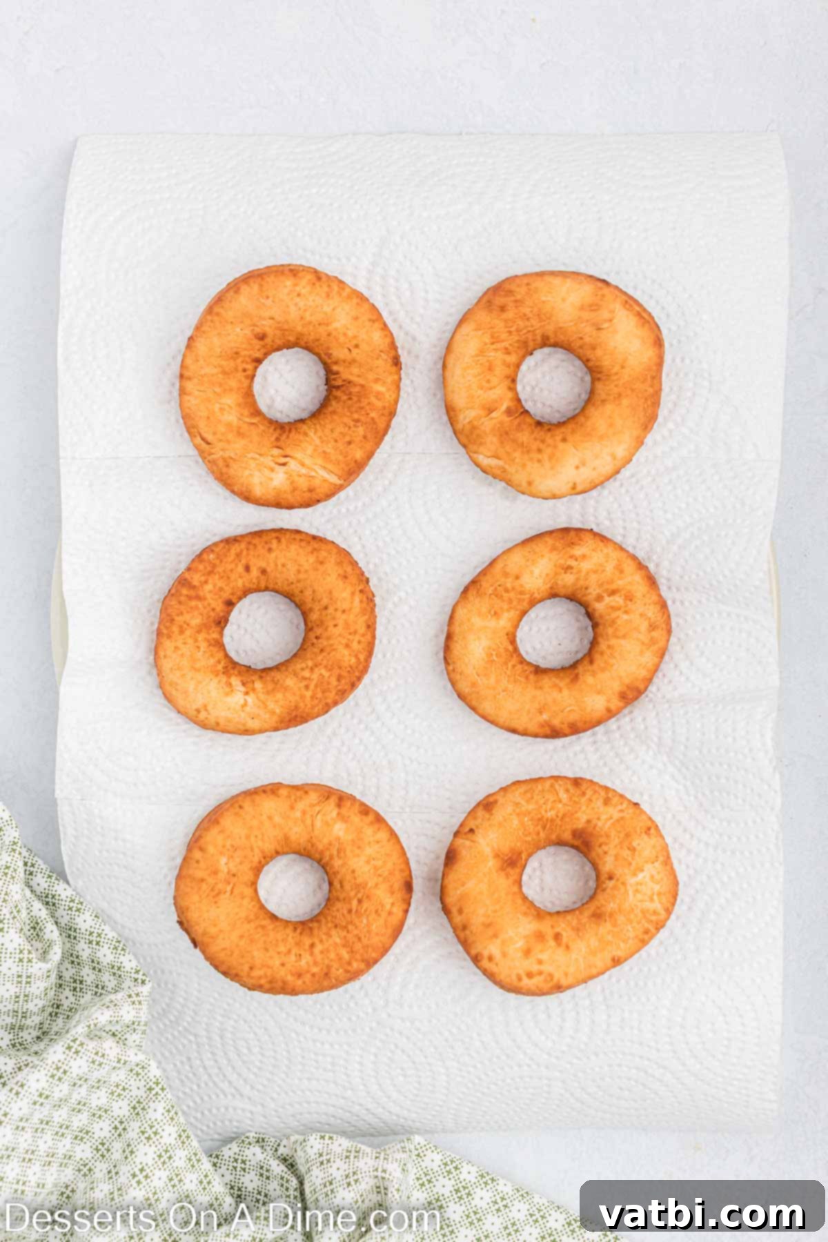 Homemade Krispy Kreme Doughnuts: The Ultimate Guide 12 Donuts fried golden brown and placed on paper towels to drain excess oil.