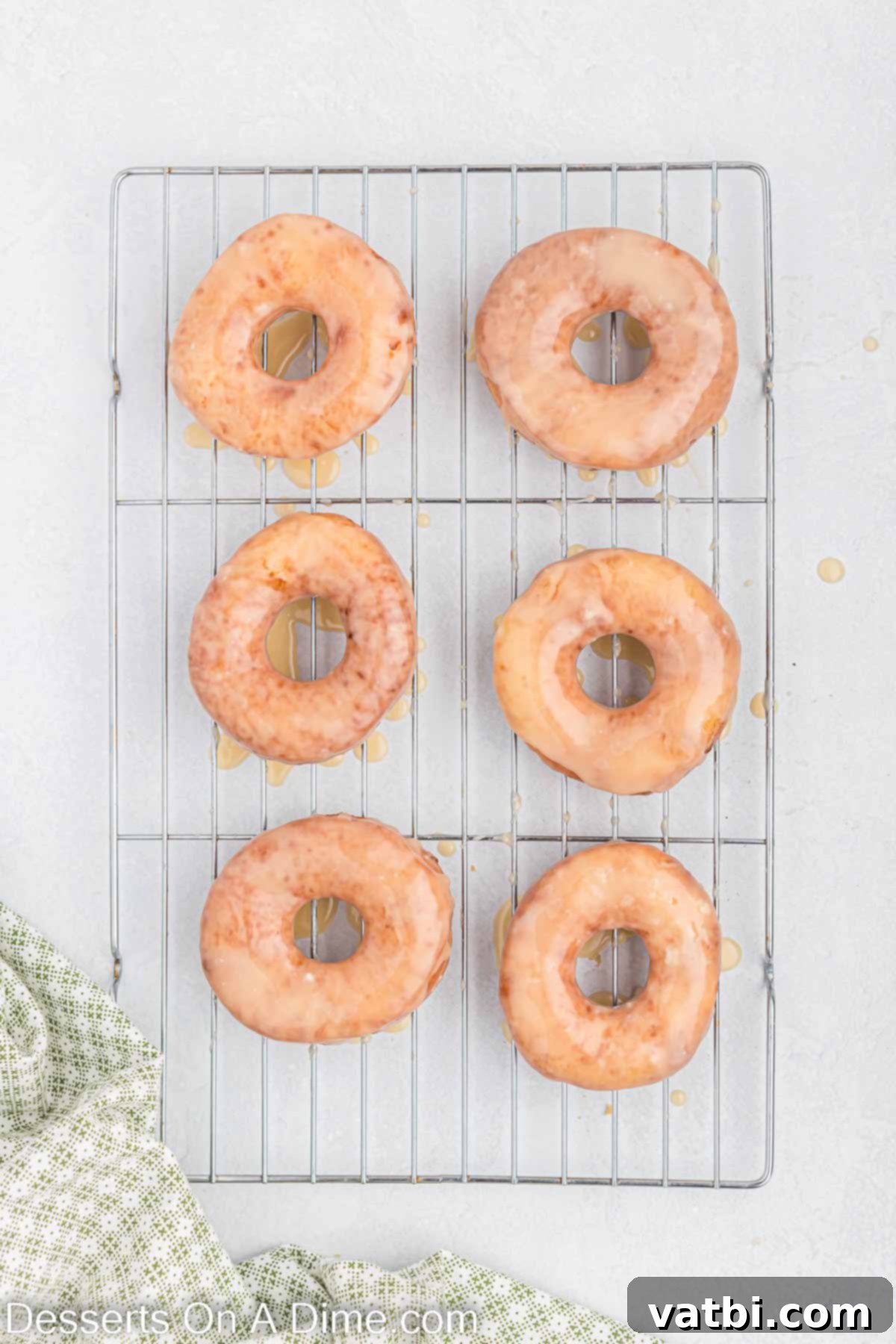 Homemade Krispy Kreme Doughnuts: The Ultimate Guide 15 Donuts dipped in glaze and placed on a wire rack to cool.