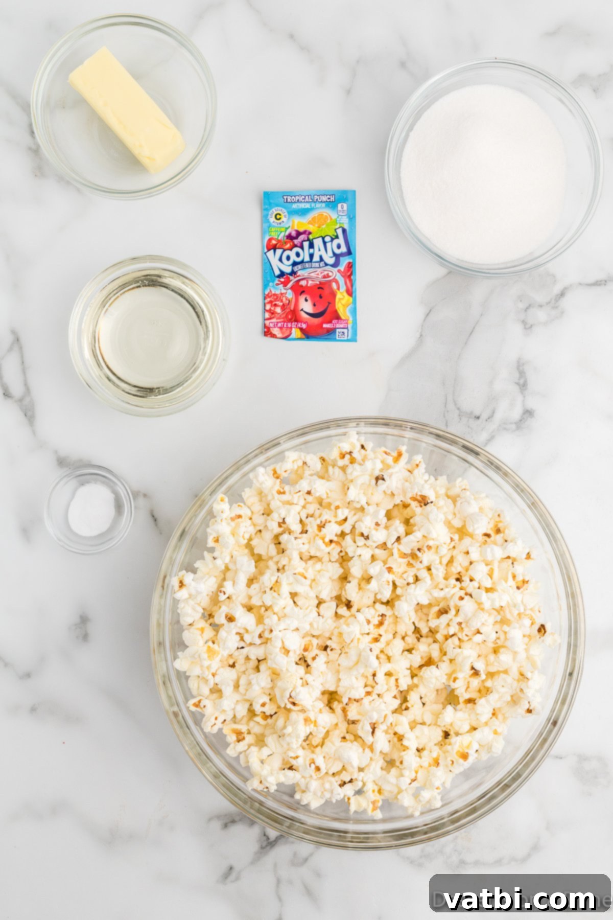 Colorful Kool-Aid Popcorn 3 Ingredients for Koolaid popcorn - popcorn, sugar, corn syrup, butter, kool-aid, baking soda.