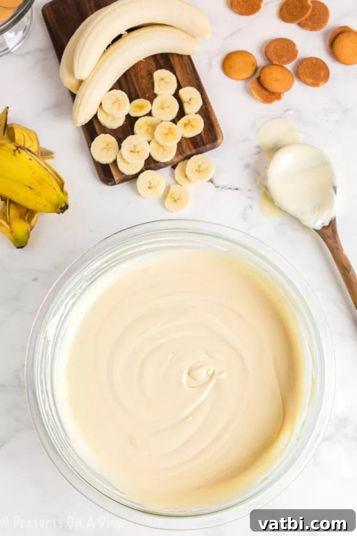 Effortless Banana Pudding Delight 2 Close-up image of sweetened condensed milk and water being mixed together in a bowl.
